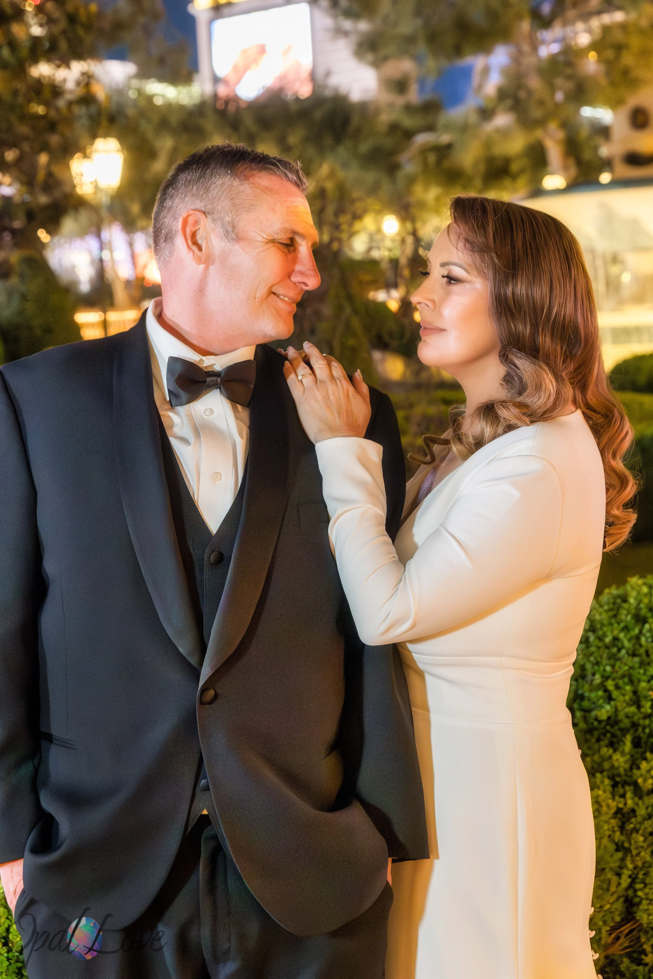 Close-up portrait of couple at Bellagio gardens with warm evening lighting