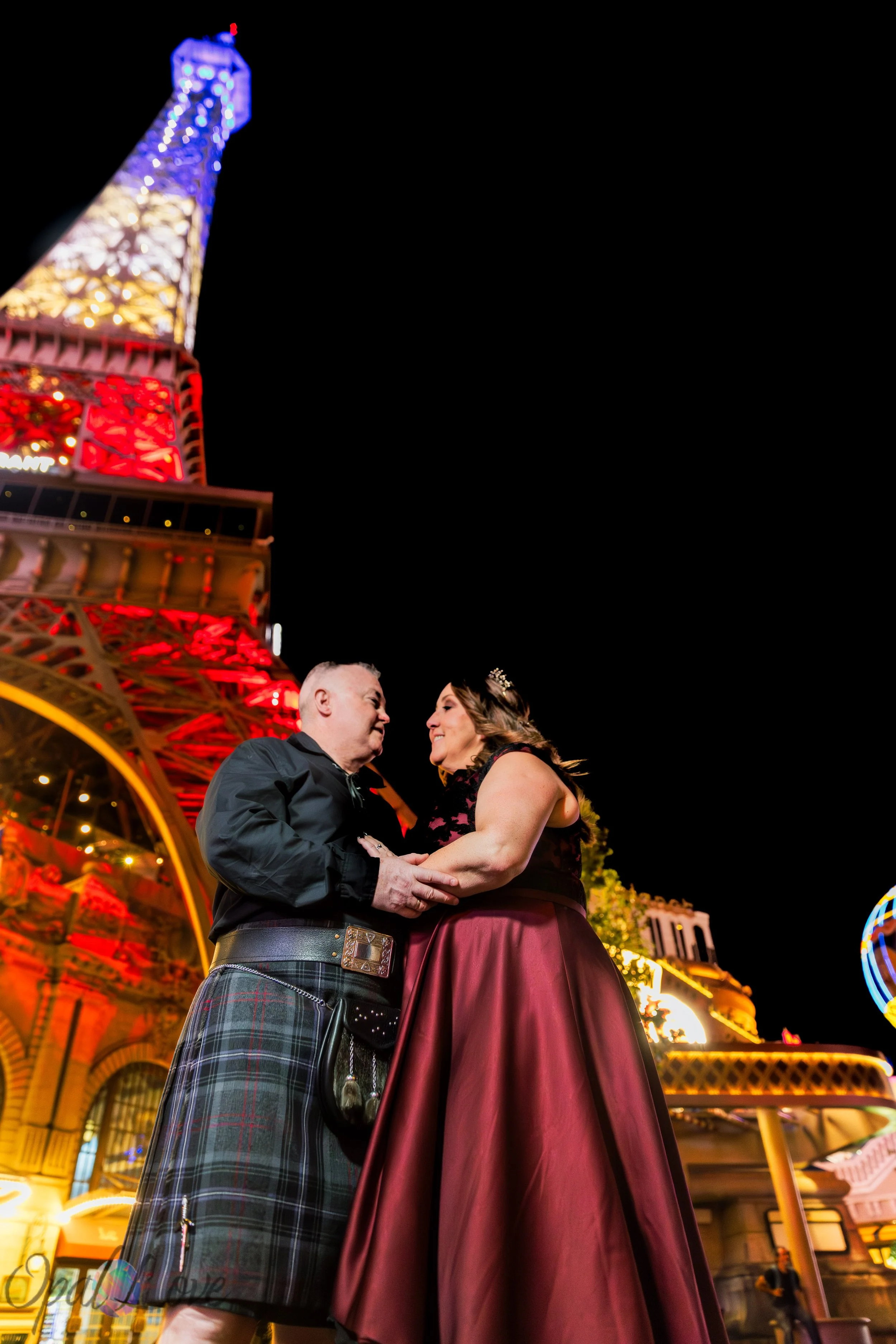 Bride and groom sharing a quiet moment beneath the Eiffel Tower at Paris Las Vegas.