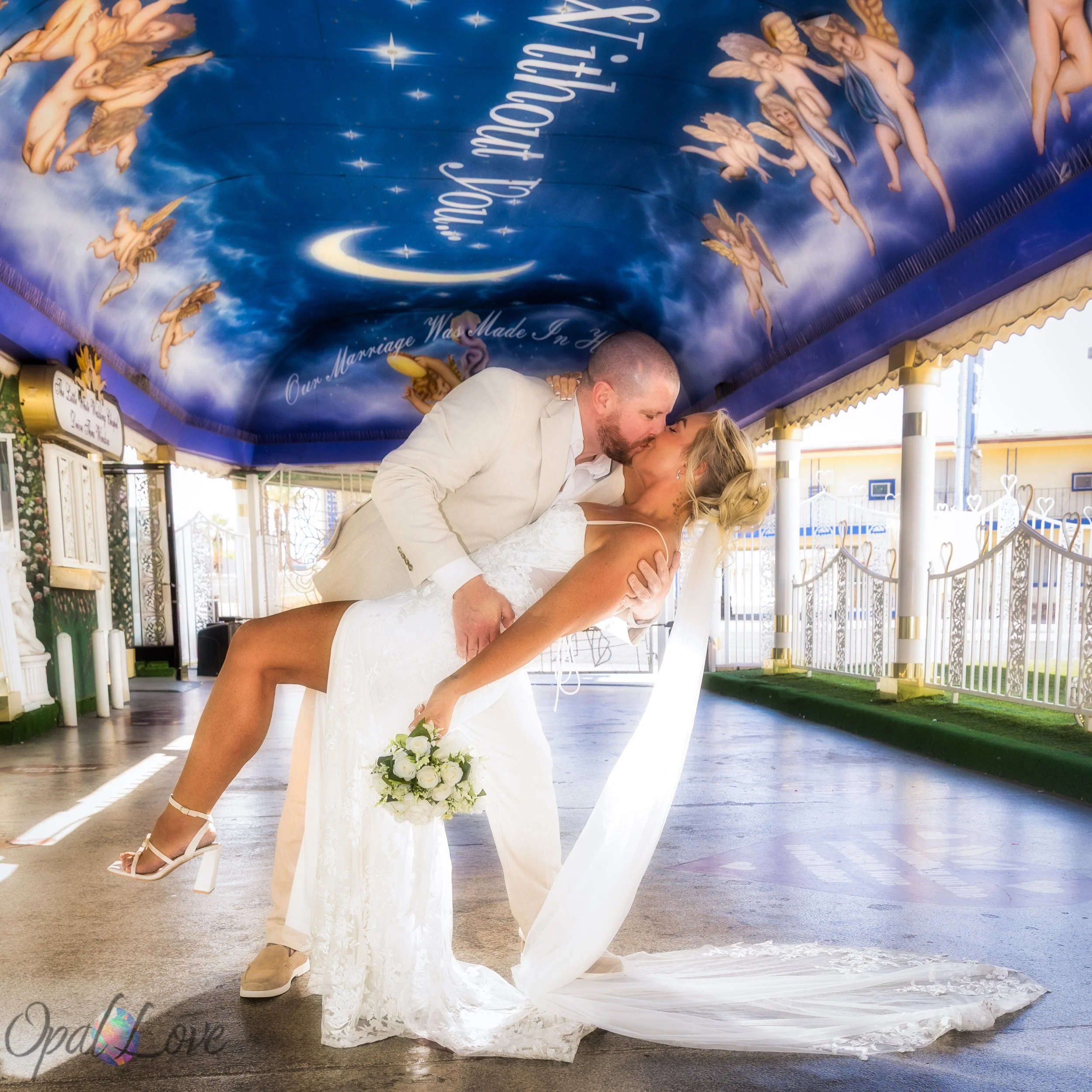 Bride and groom kissing at the Little White Wedding Chapel during an intimate Las Vegas elopement ceremony