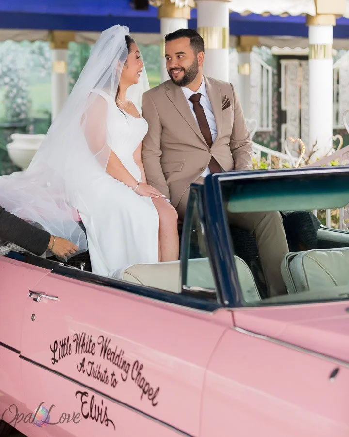 Couple during their wedding ceremony in the pink Cadillac at the Little White Wedding Chapel in Las Vegas.