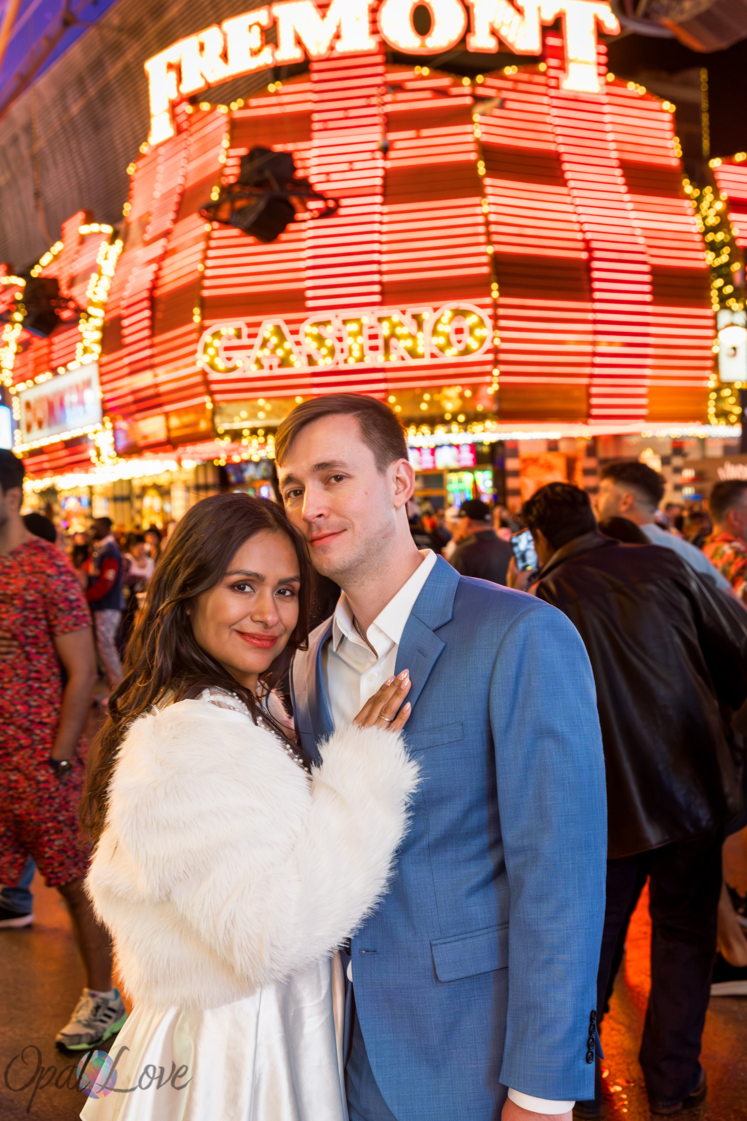 Couple posing together in front of Fremont Casino sign on Fremont Street Experience