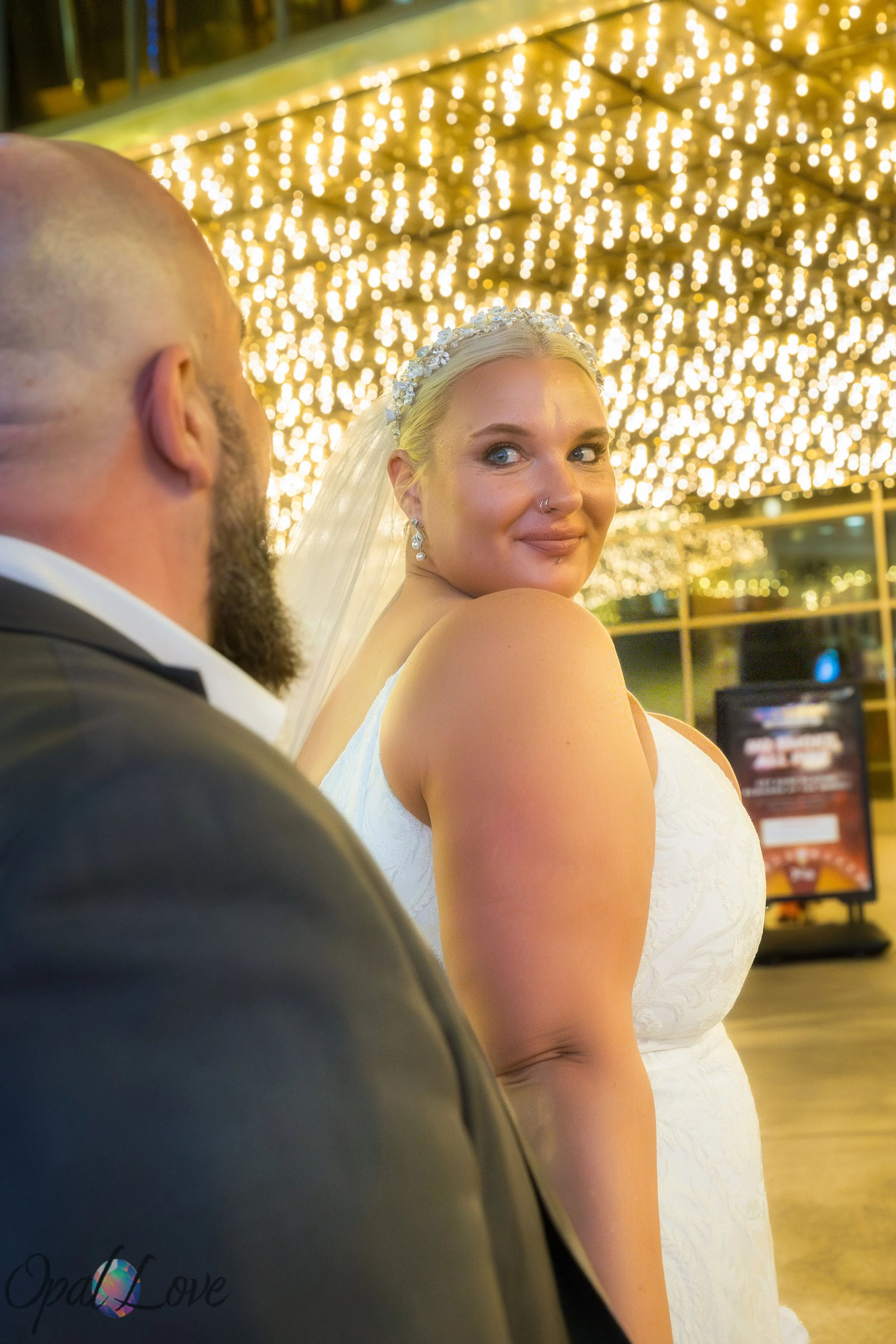 Candid Fremont Street wedding photo in Las Vegas with bride under the canopy lights during an evening photo tour