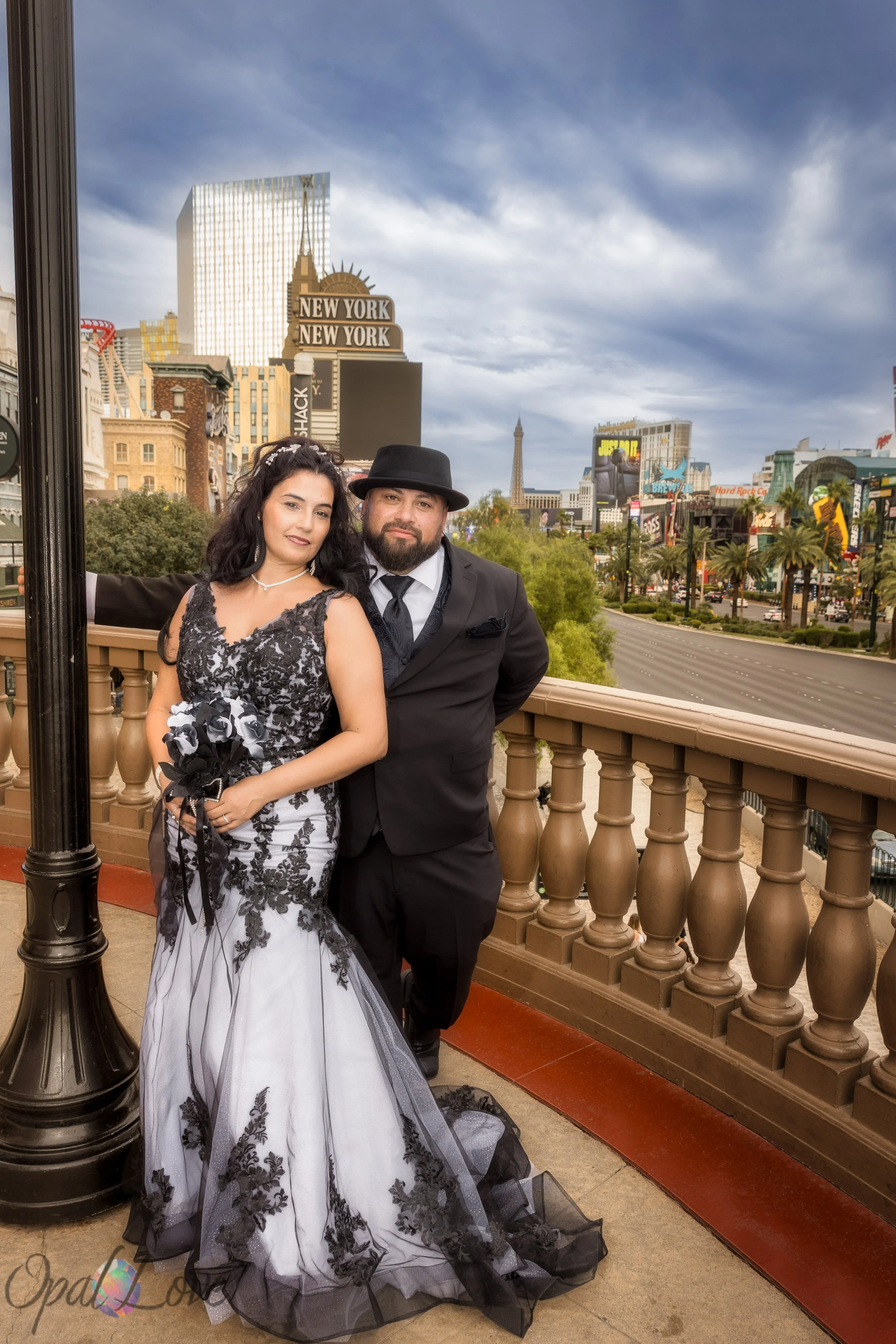 Couple standing on a balcony overlooking the Las Vegas Strip near New York New York.