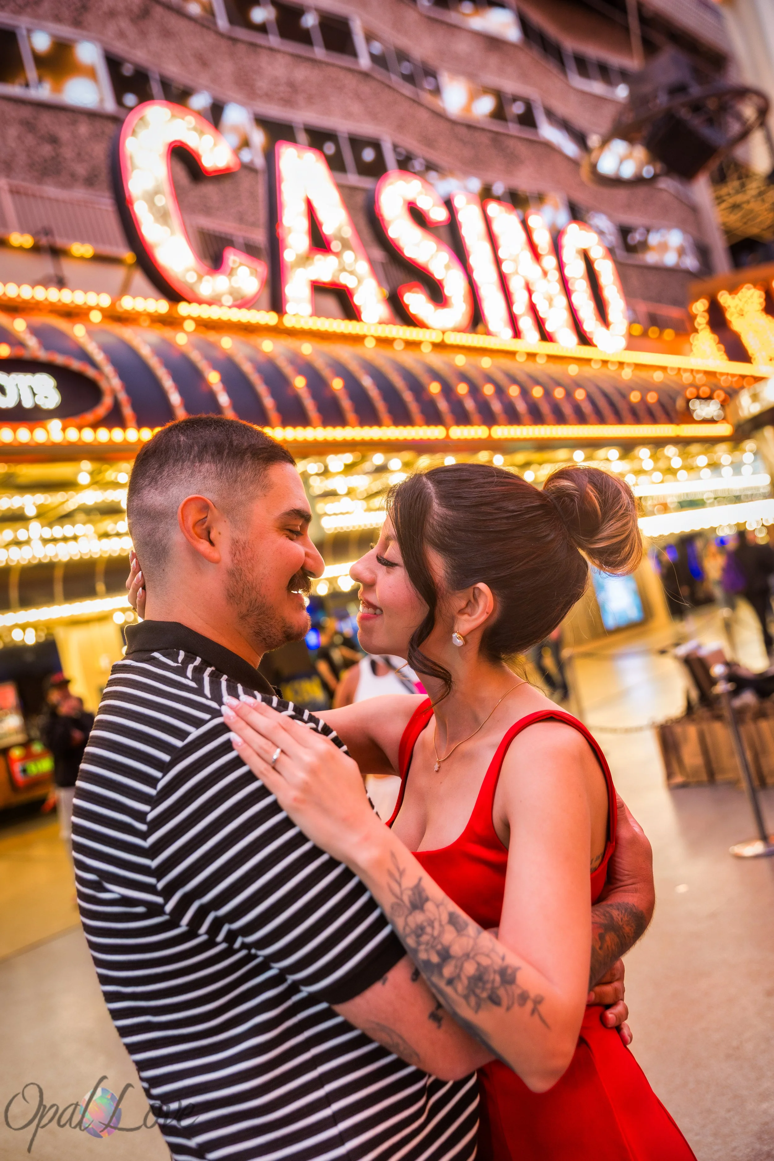 Couple embracing near casino lights on Fremont Street in Downtown Las Vegas