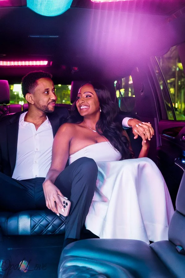 Newlywed couple kissing beneath illuminated marquee lights in Las Vegas