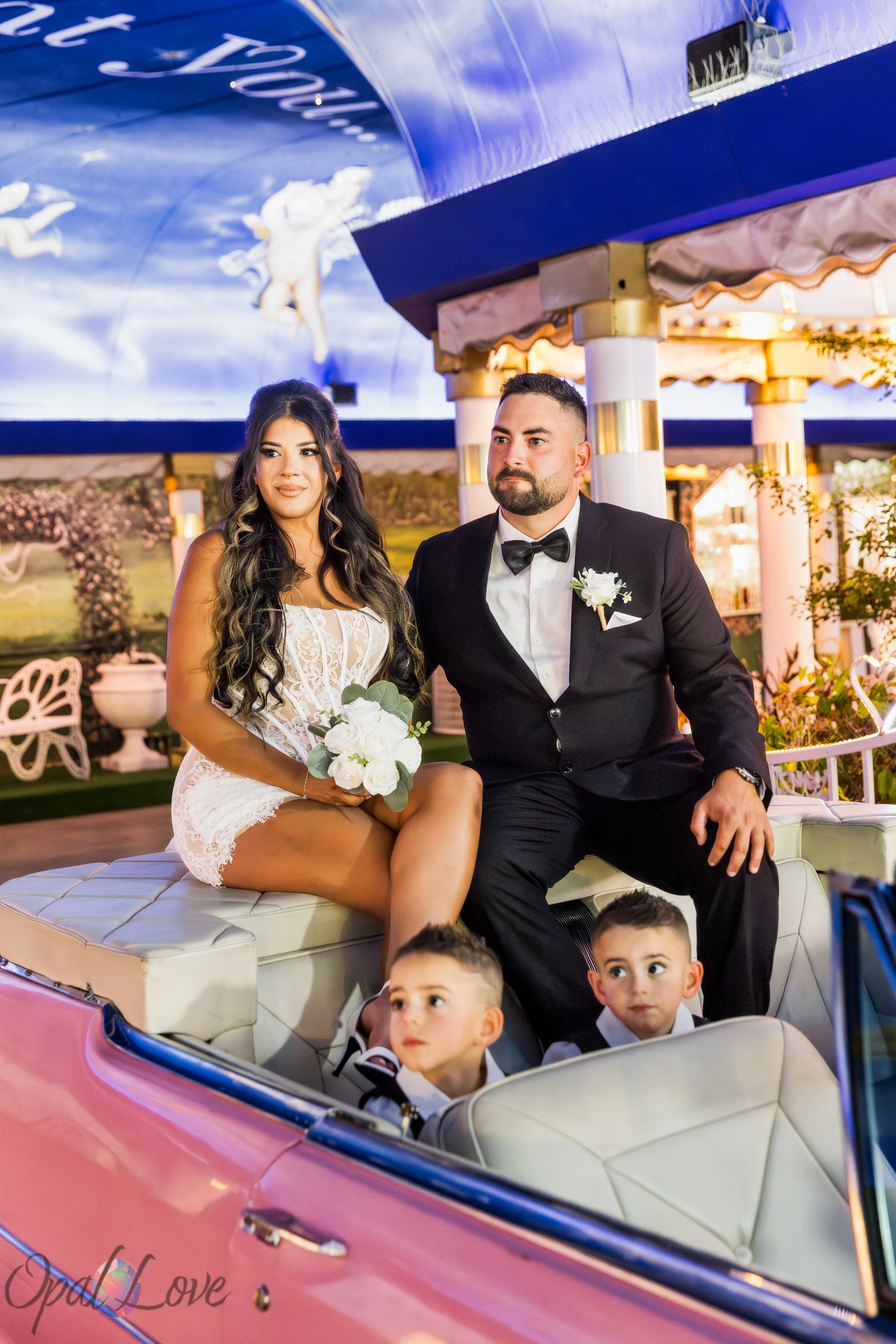 Alysha and Justin with their children in the pink Cadillac at the Little White Wedding Chapel in Las Vegas.