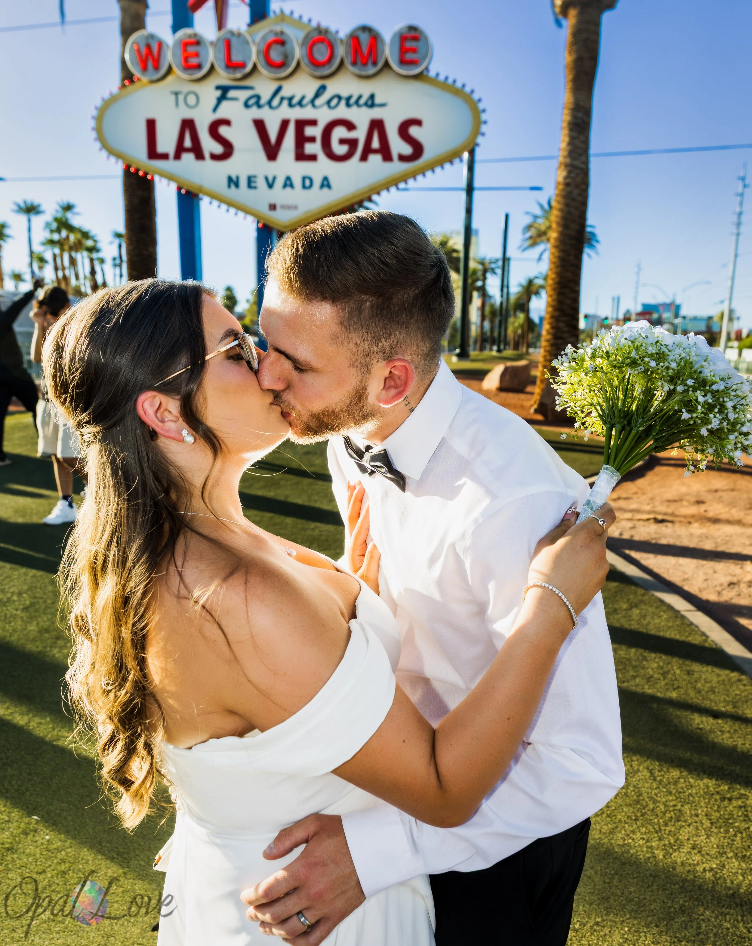 Bride and groom sharing a kiss at Little White Wedding Chapel after their Las Vegas wedding ceremony.