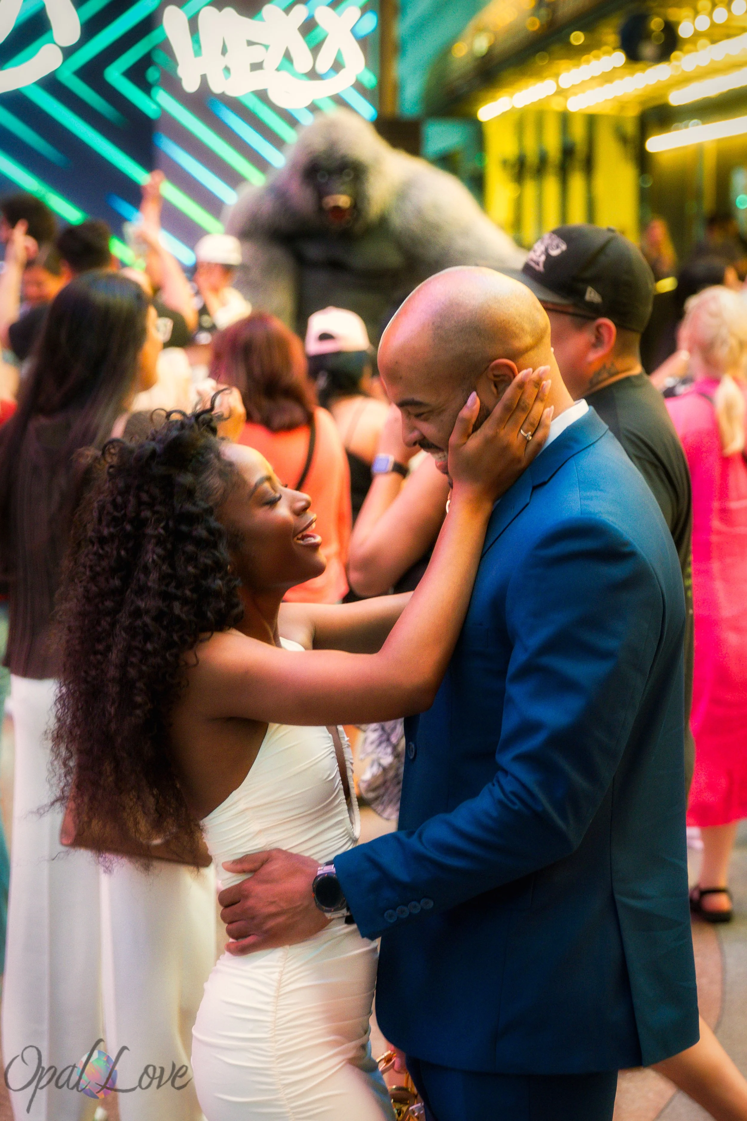 Couple laughing together near neon signs along Fremont Street during a Las Vegas photo tour.