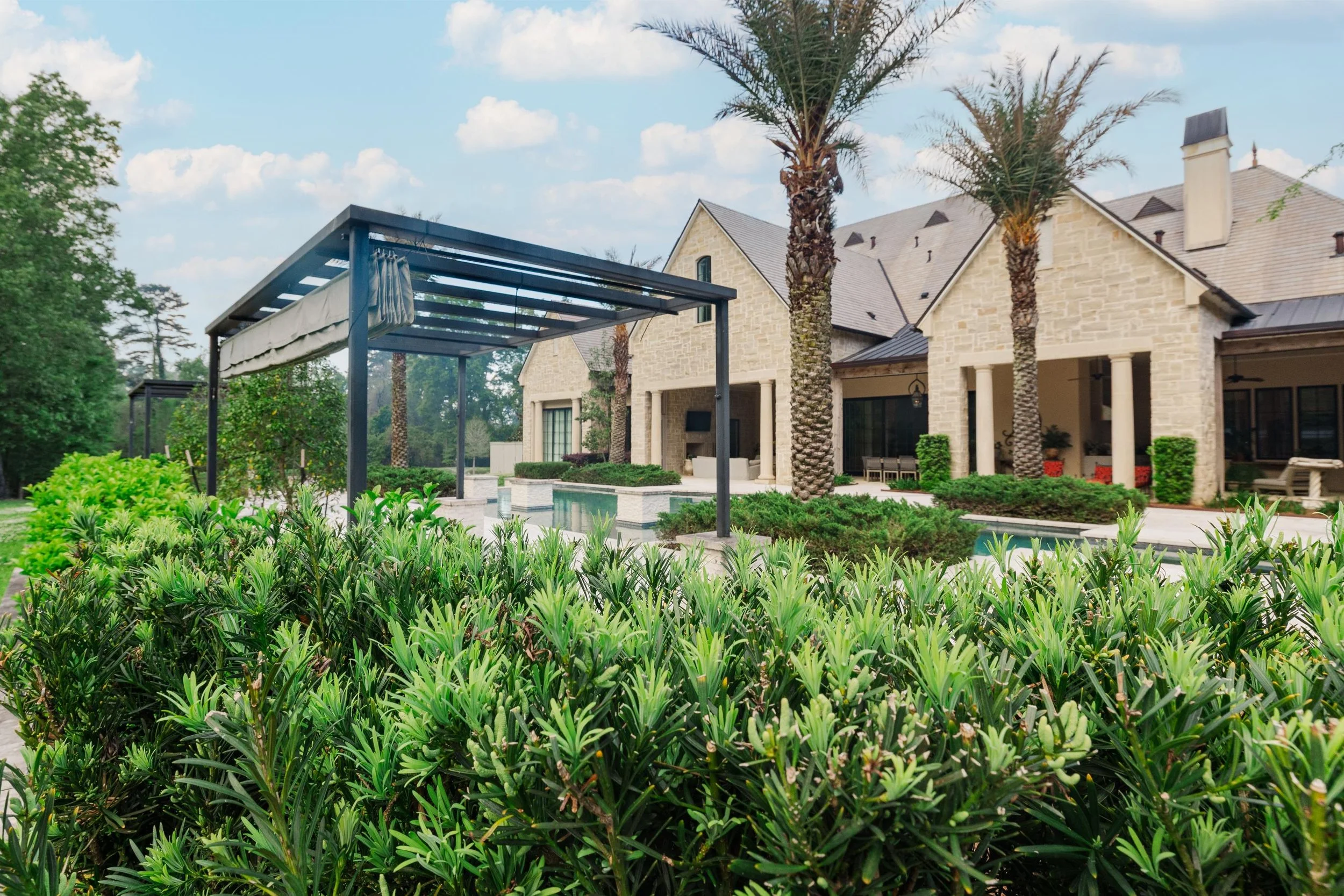 Residential estate landscaping with symmetrical hedges and manicured grounds