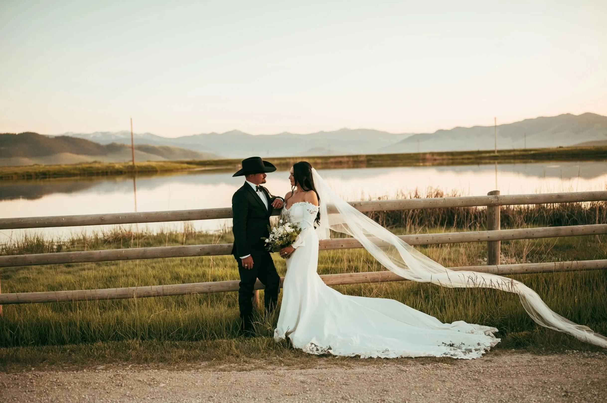Luxury western bride and groom celebrating at an elegant outdoor wedding in Missoula, Montana with scenic mountain views and romantic golden light.
