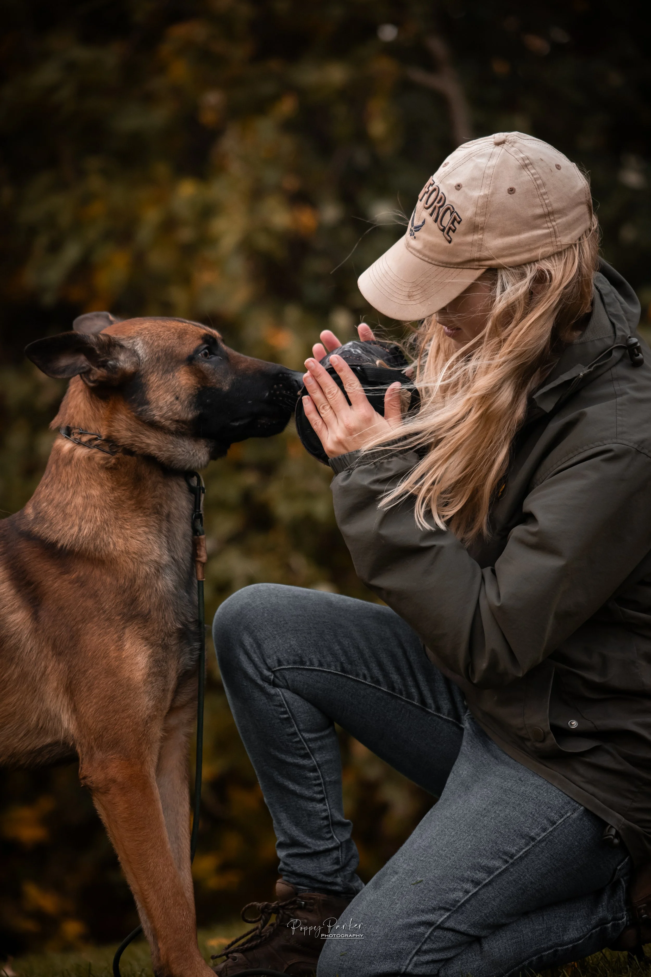 dog trainer and herder playing tug with toy