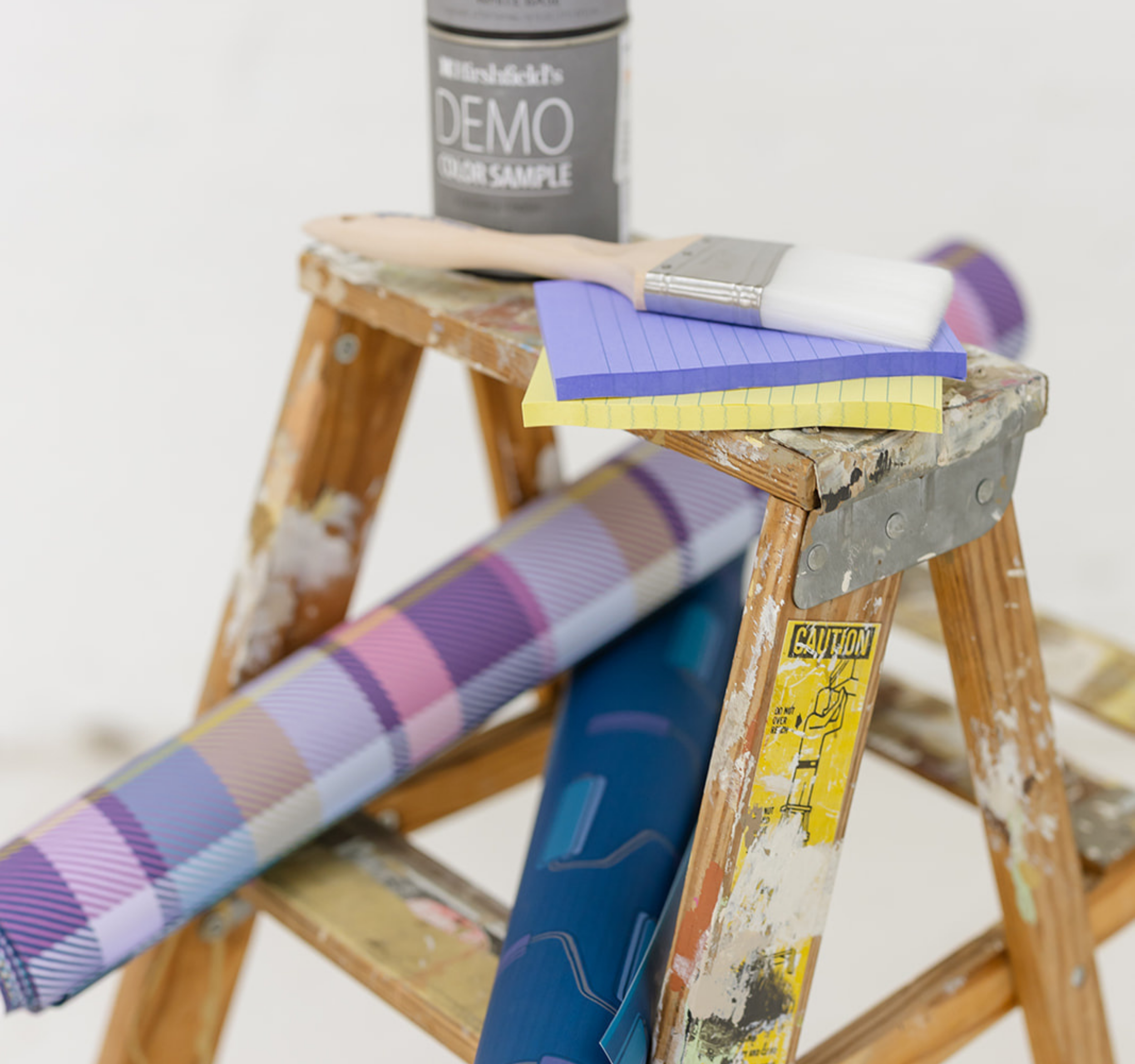 Brand photography for The List by Allie Marie Design featuring a wooden ladder with Hirshfield's paint samples, custom plaid wallpaper patterns, and professional painting tools for a Minneapolis creative installation project.