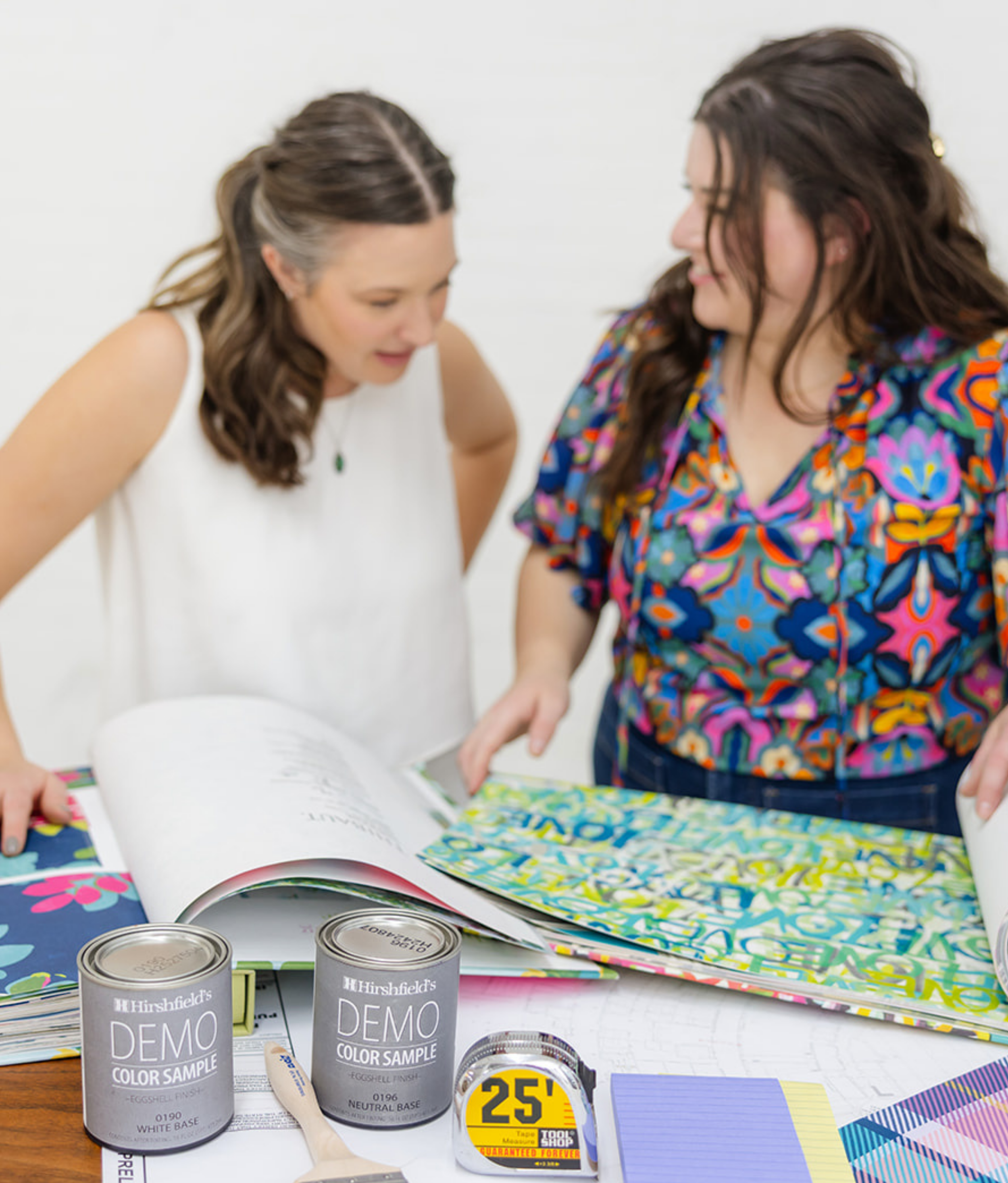 The List team reviewing vibrant patterns and Hirshfield's paint color samples for a Minneapolis home installation project, featuring brand photography for the identity designed by Allie Marie Design.