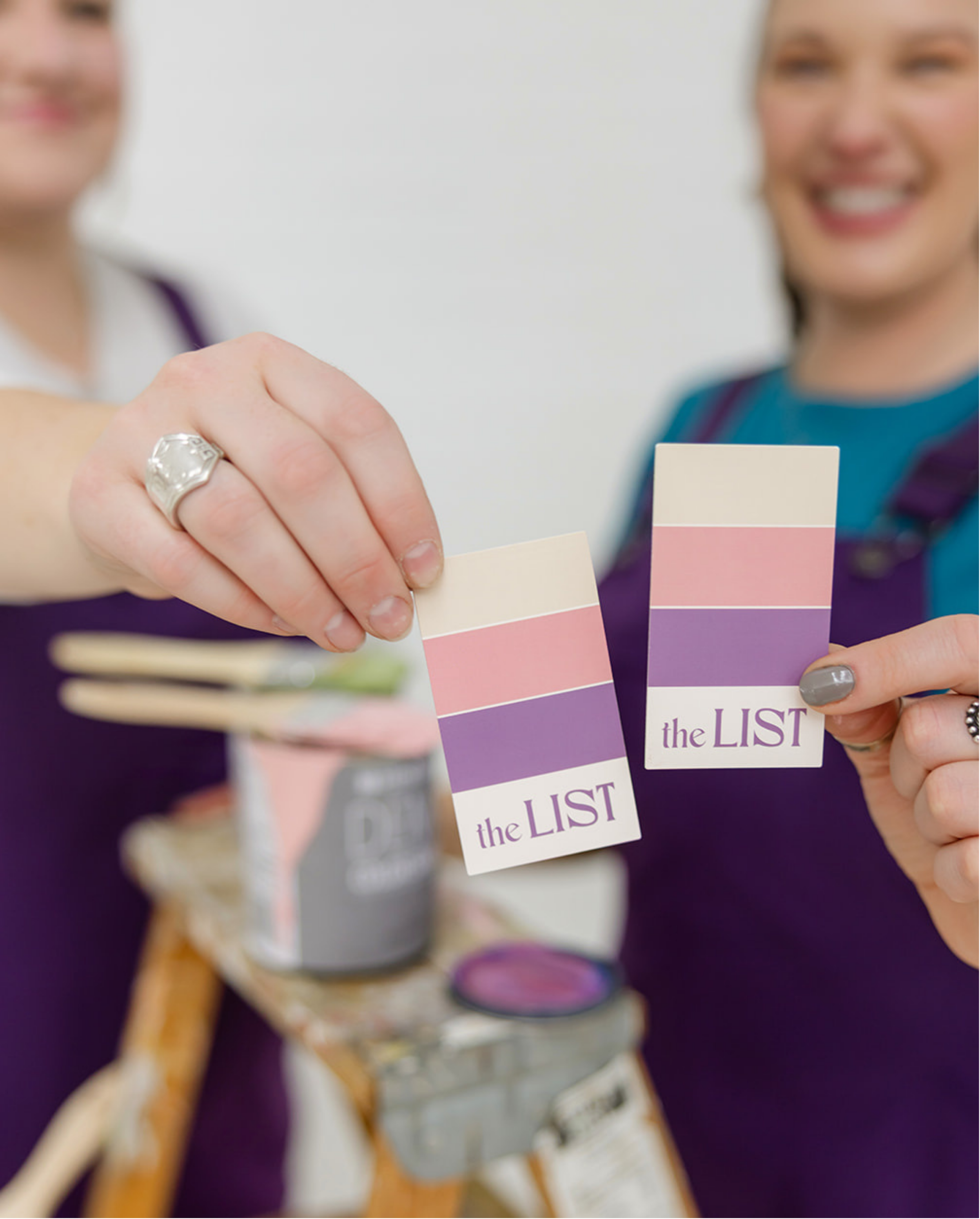 Modern business card design for The List featuring custom brand color palettes and logo, held by the creative team in a lifestyle setting, designed by Allie Marie Design.