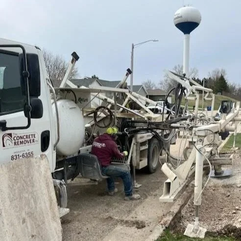 Concrete curb cutting machine with operator