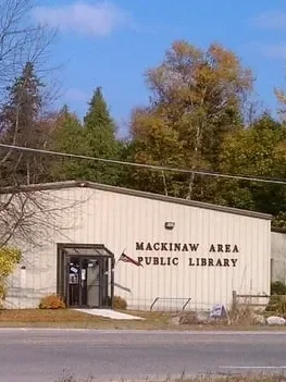 Mackinaw Area Public Library building with trees in the background.