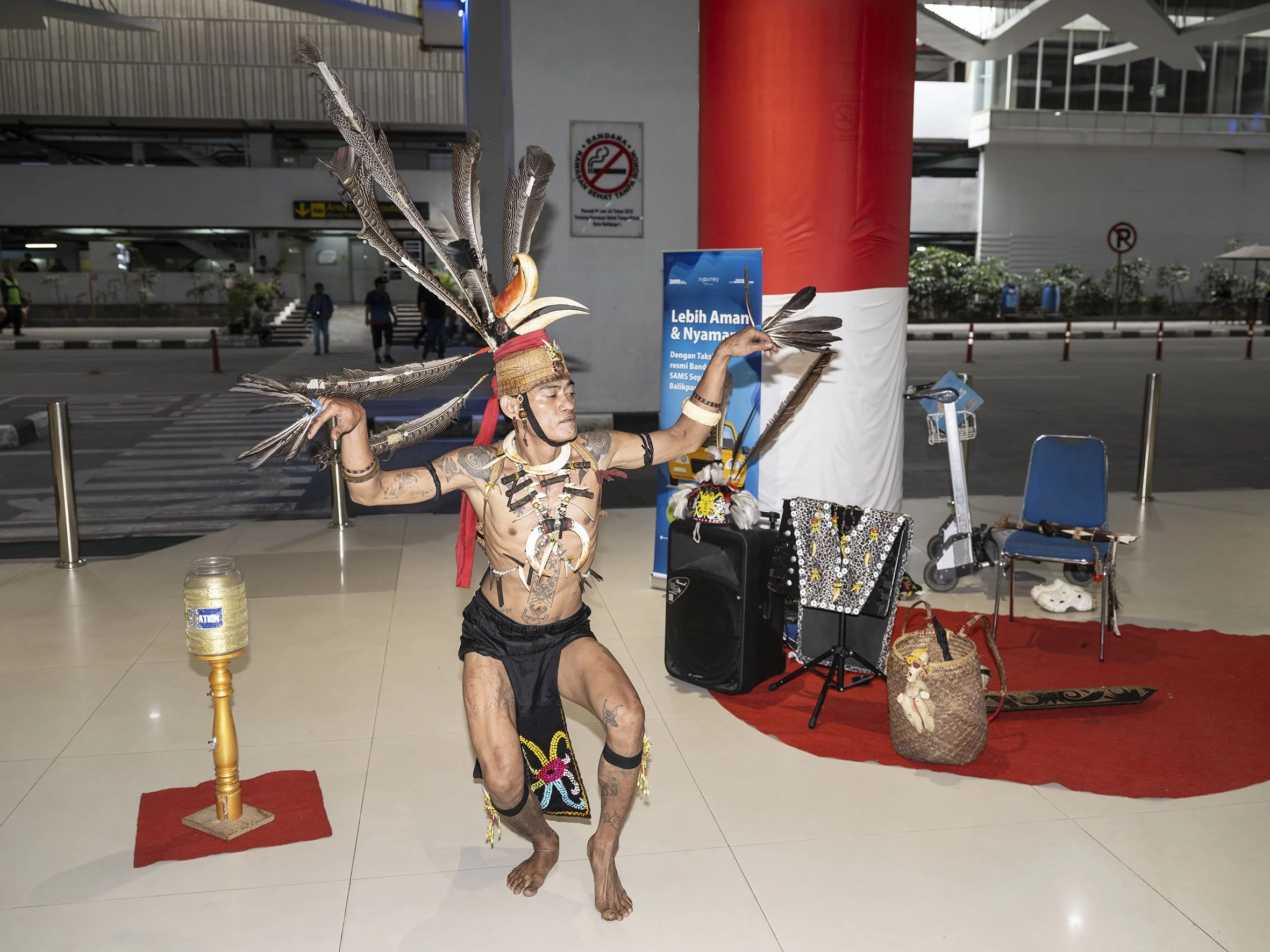 Agus Leo Putra performs traditional Dayak dances in front of the arrivals hall at Balikpapan Airport in East Kalimantan to welcome visitors. August 15, 2025