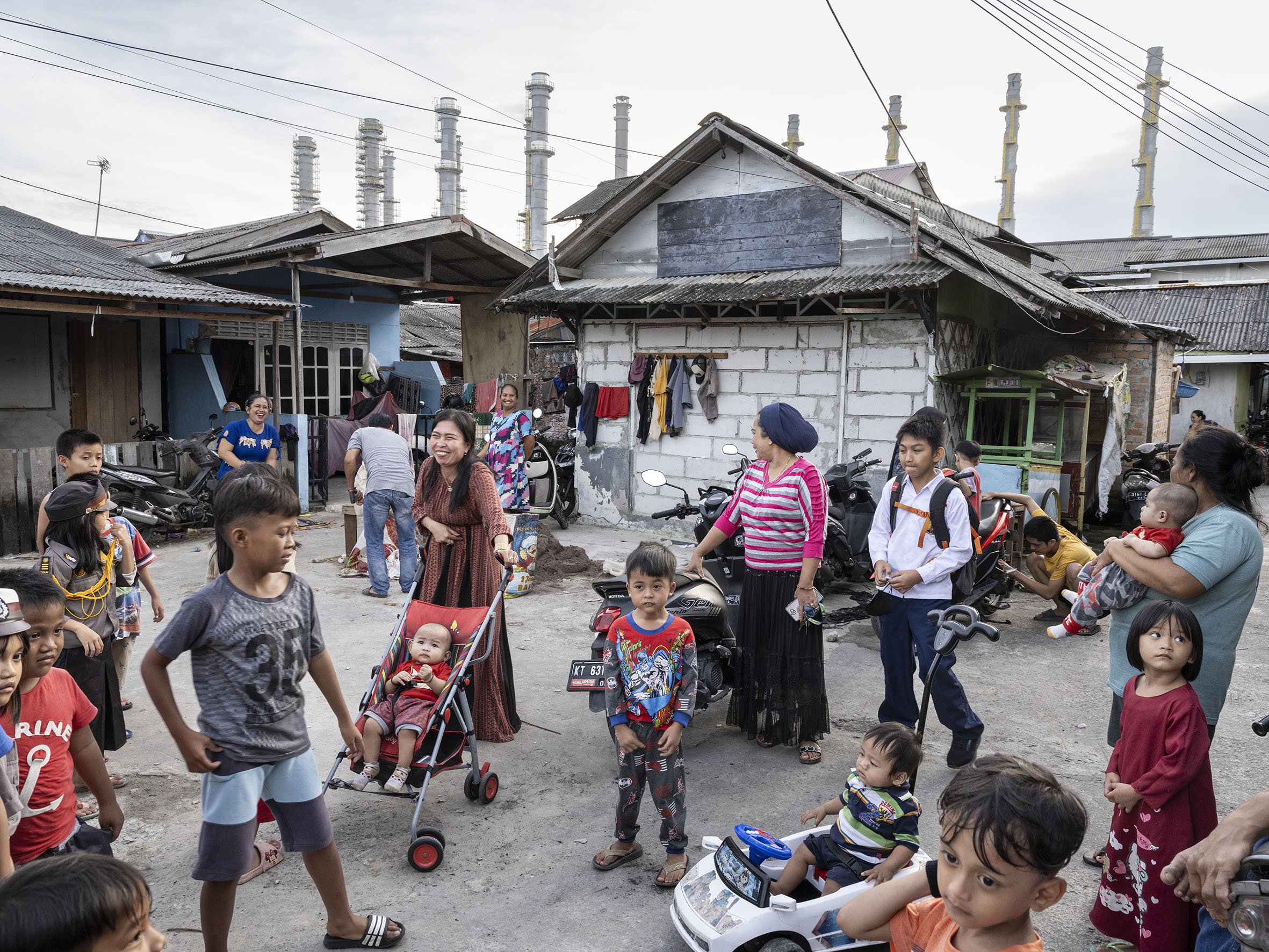 The fishing community of Kampung Baru in Balikpapan lives near the polluting refinery of state-owned oil company Pertamina, whose smokestacks can be seen in the background.  September 6, 2022 