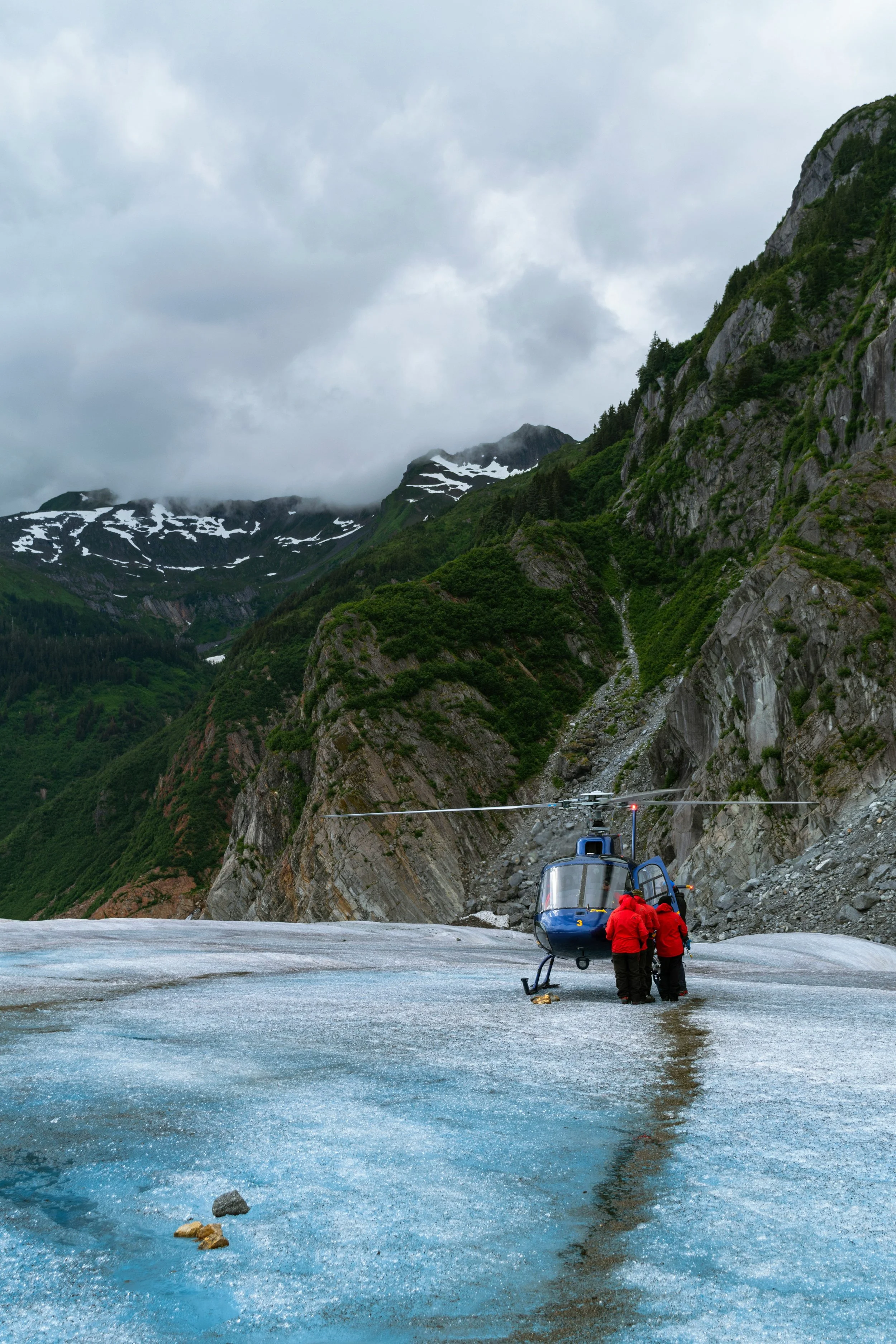 couple on glacier with helicopter