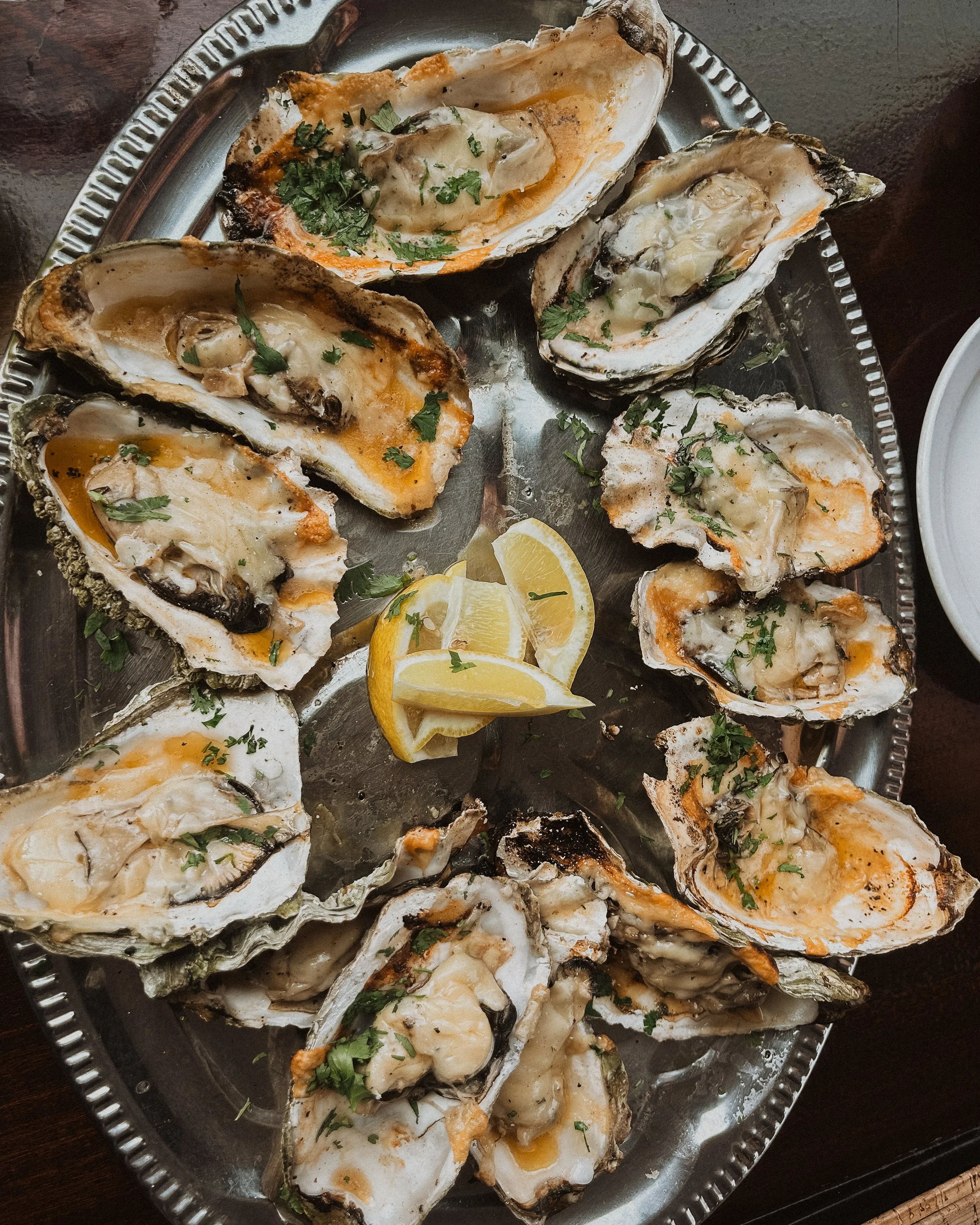 oysters surrounding mound of sliced lemons
