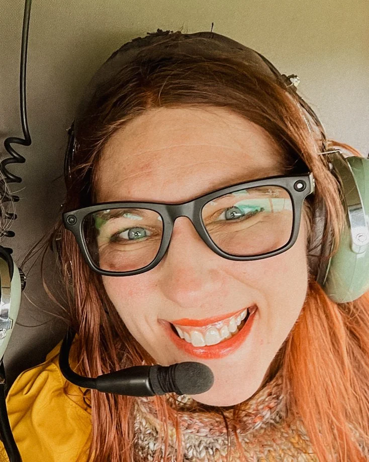 Paige Kleckner in black glasses and helicopter headphones