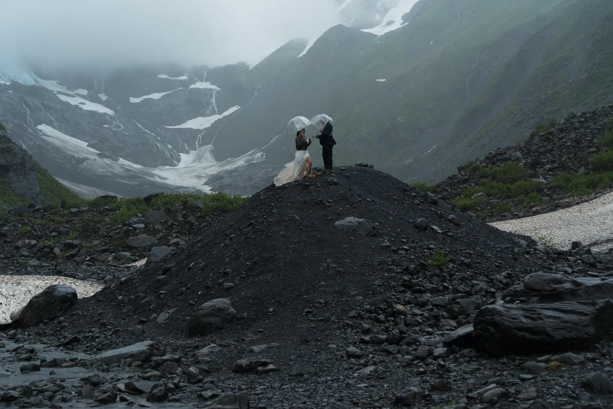 eloping bride and groom saying their vows on black rocks of Byron Glacier in Alaska