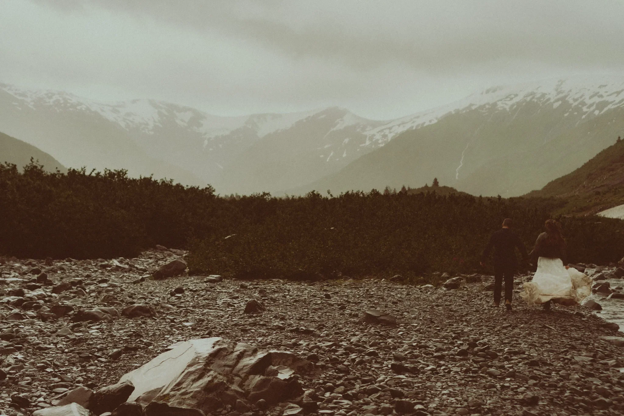 elopement couple running on Byron glacier in Alaska