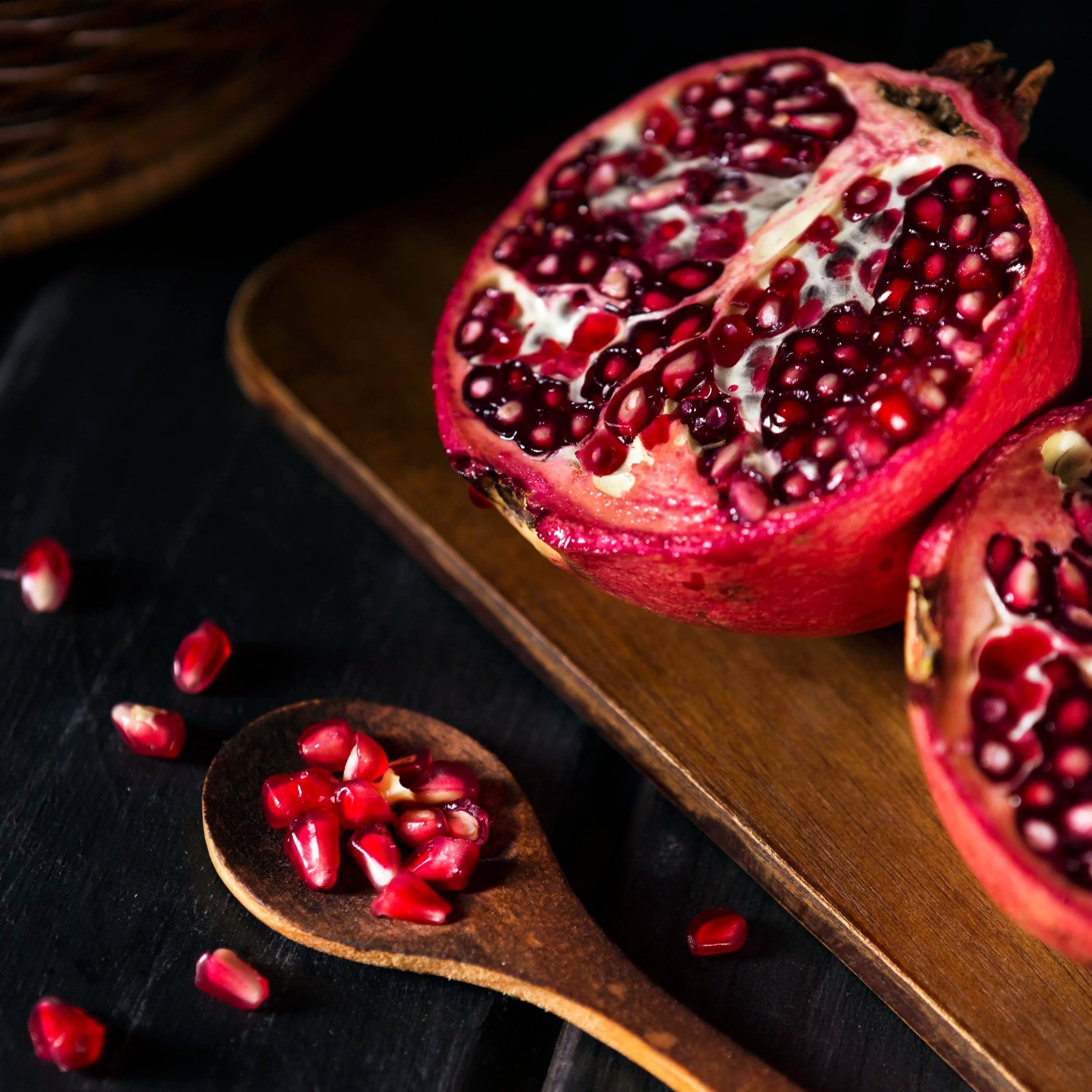 high-angle-pomegranate-fruit-with-wooden-spoon.jpg