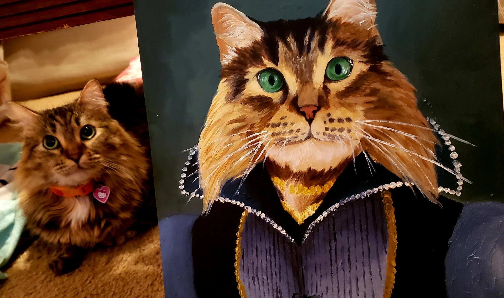 A close-up photo of a realistic painting of a cat with green eyes and a black and orange striped fur pattern, wearing a black jacket with a pearl necklace. To the left, there is a real cat with similar fur color and pattern, wearing an orange collar and pink heart-shaped tag.
