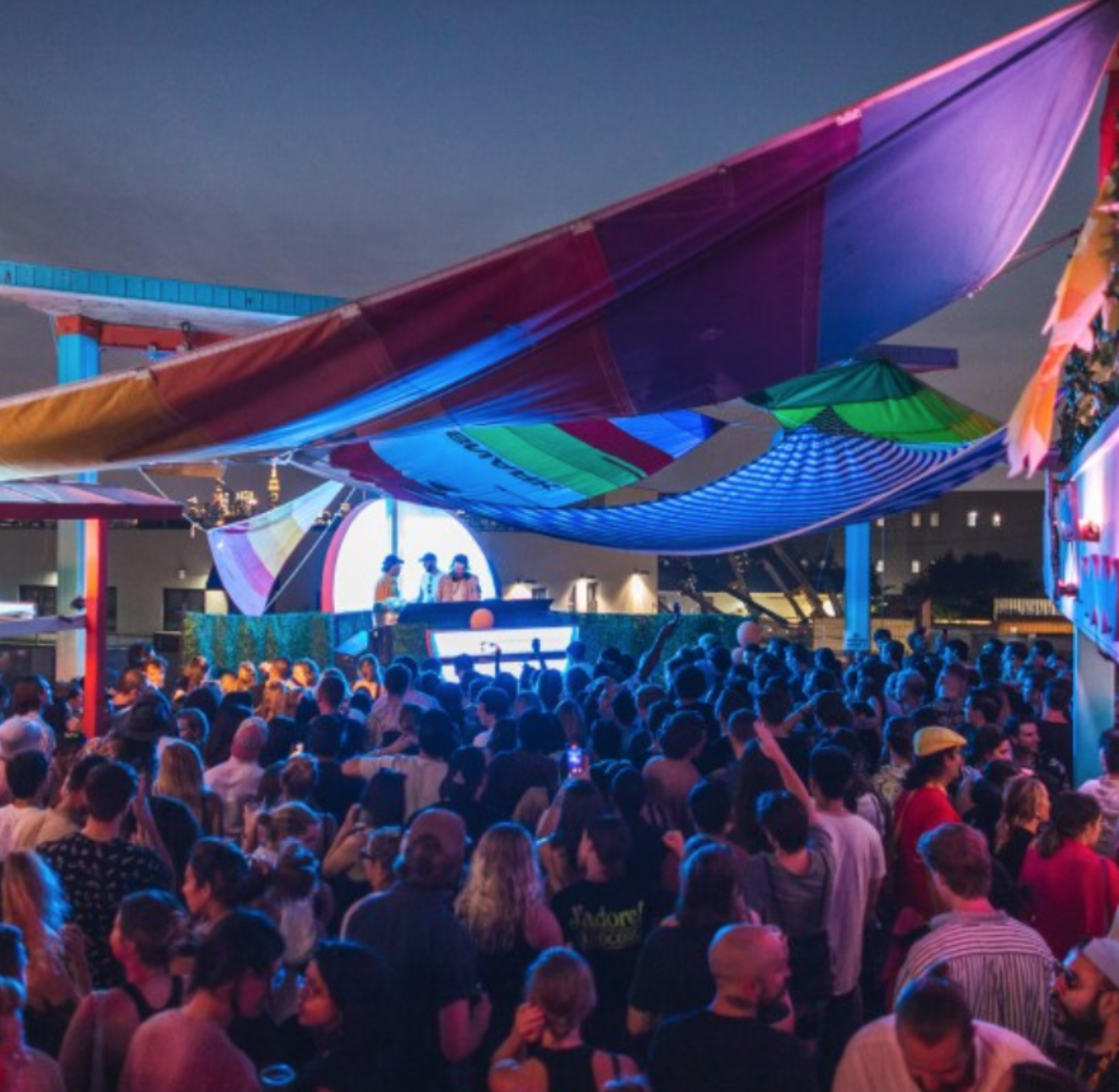crowd at elsewhere's rooftop stage in brooklyn at dusk