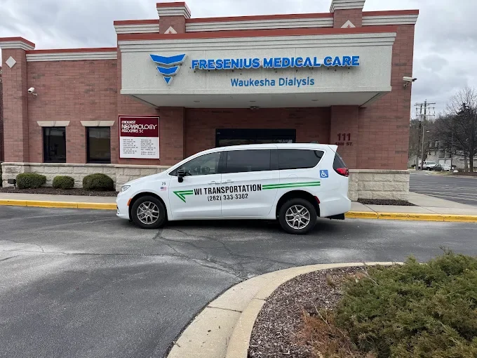 A white Wisconsin Transportation vehicle is parked outside Fresenius Medical Care in Waukesha, Wisconsin.