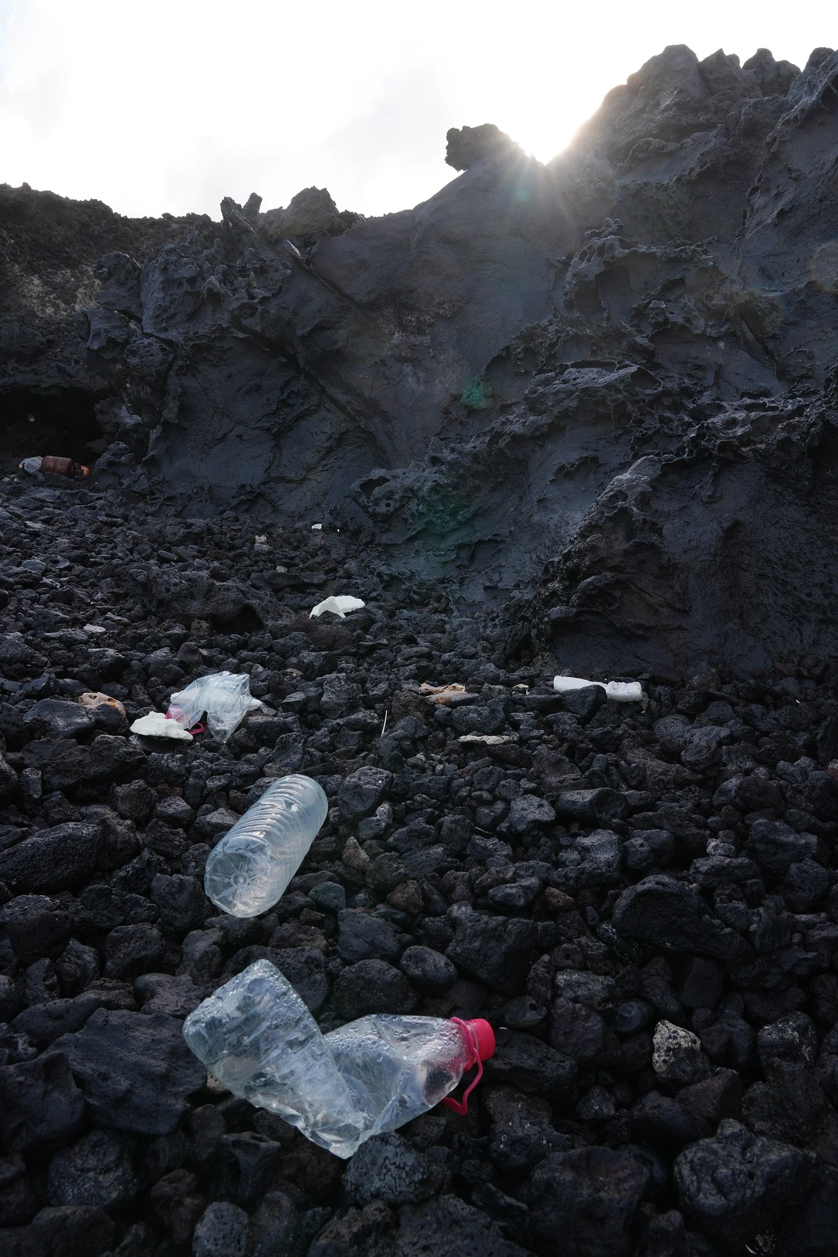 8 Plastic on beach by cliff with light beam.jpg