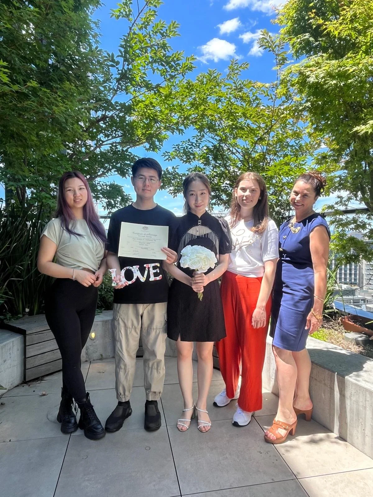 Proud couple at wedding with guests.jpeg