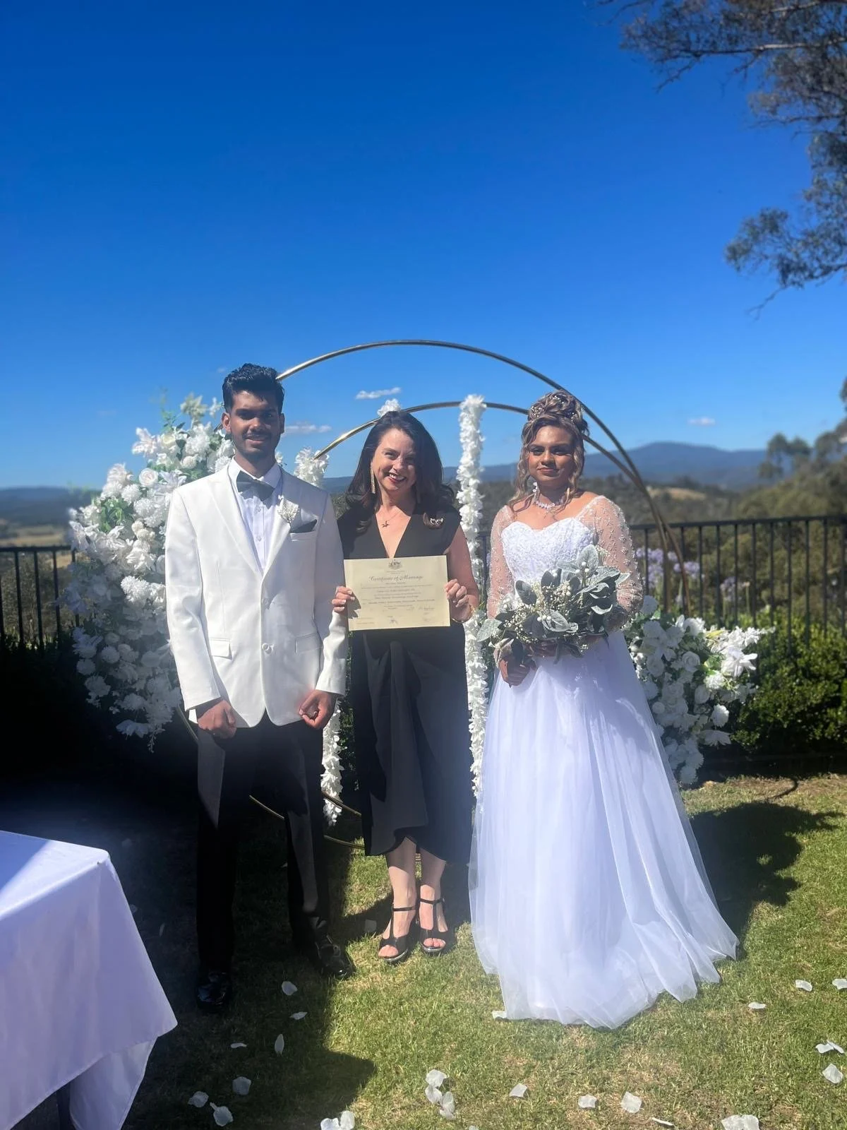 Dee with married couple and marriage certificate.JPG