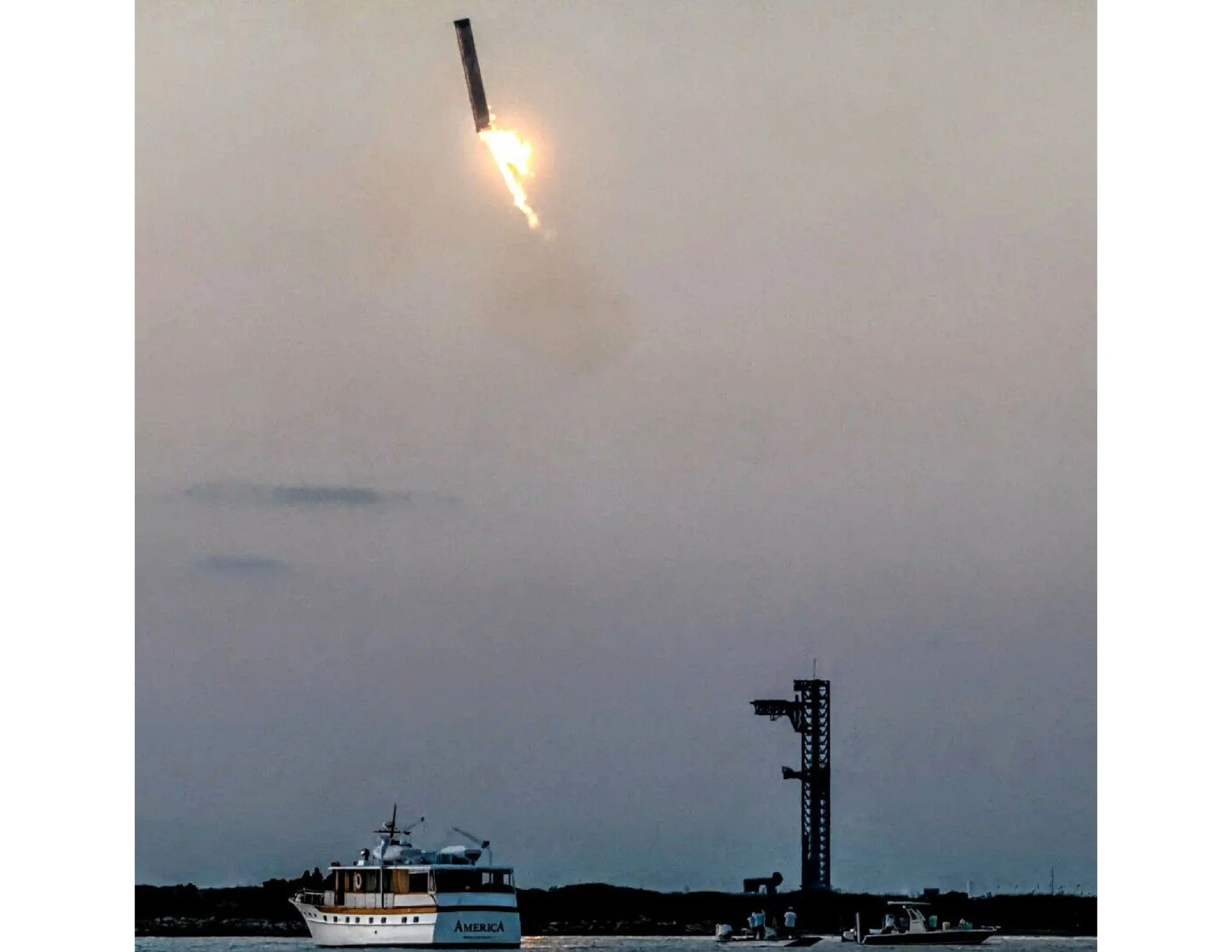 A boat named 'America' on the water, a ship launching firework in the sky, and a lighthouse on the shoreline.