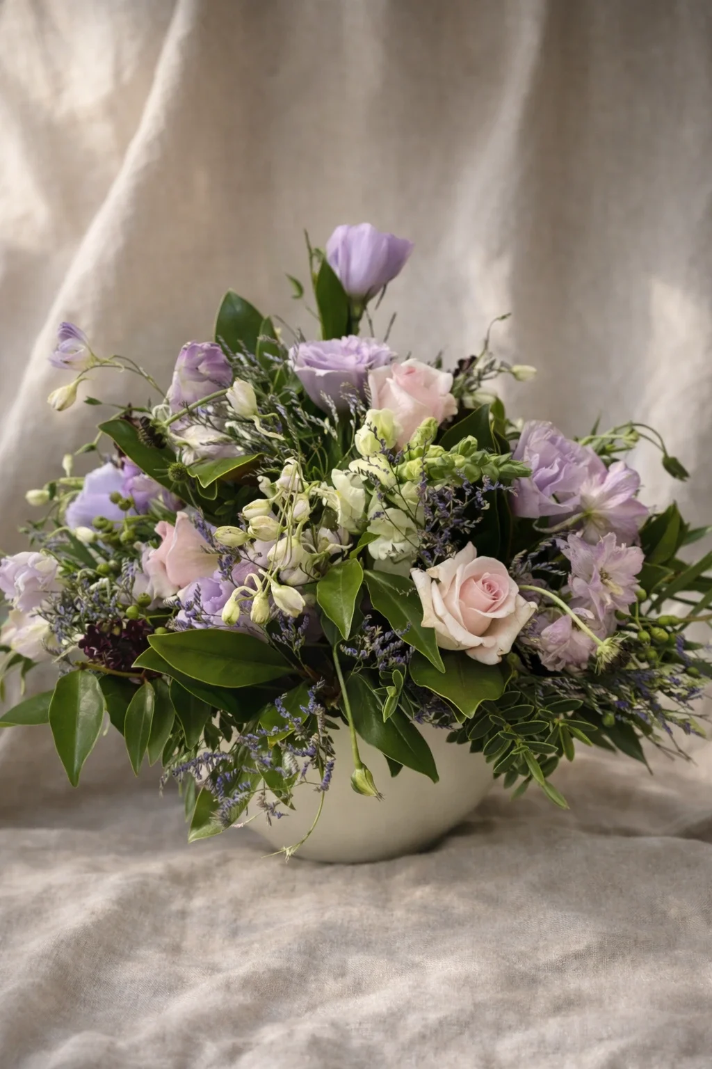 Colorful flower Arrangement with pink roses, purple, and white flowers in a white pot. Hospital Flowers, Delivery available Hastings, Havelock North & Napier.