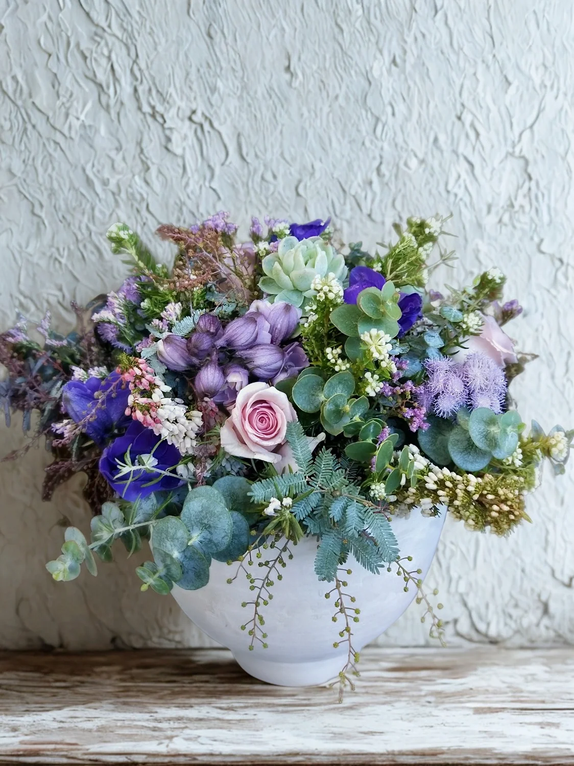 Colorful flower bouquet with pink roses, purple, and white flowers in a white pot with black and white ribbon. Hospital Flowers, Delivery available Hastings, Havelock North & Napier.