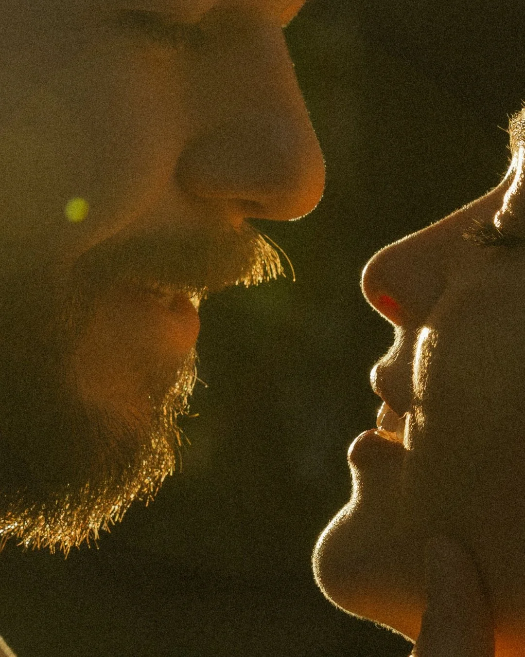 Close-up golden hour portrait of couple’s faces