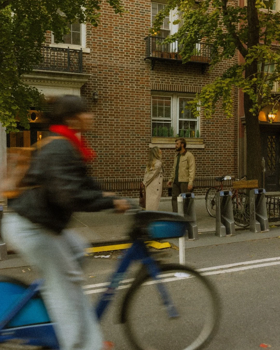 Couple walking past bike in West Village