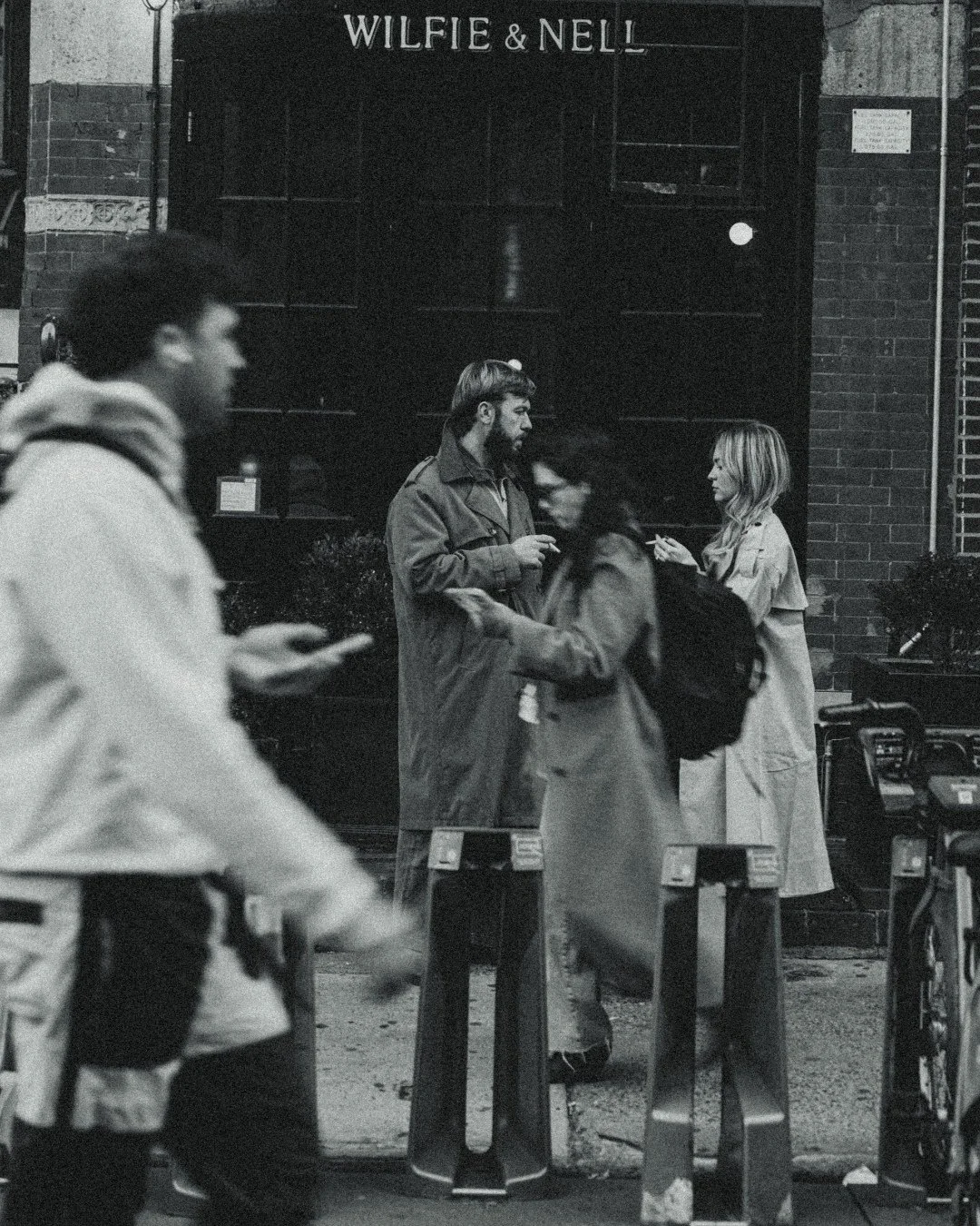 Couple smoking in West Village with vintage trench coats