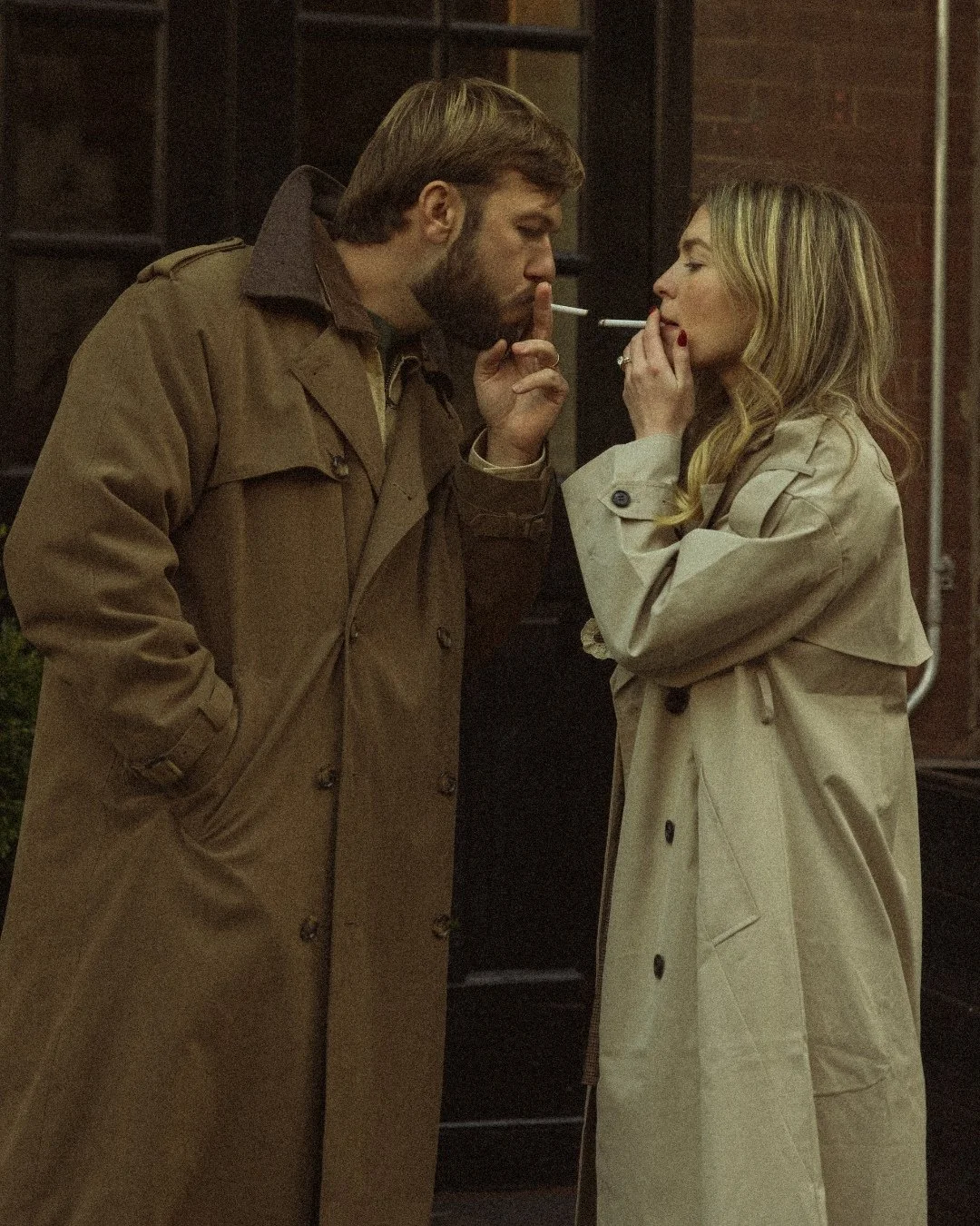 Vintage trench coat couple smoking in West Village