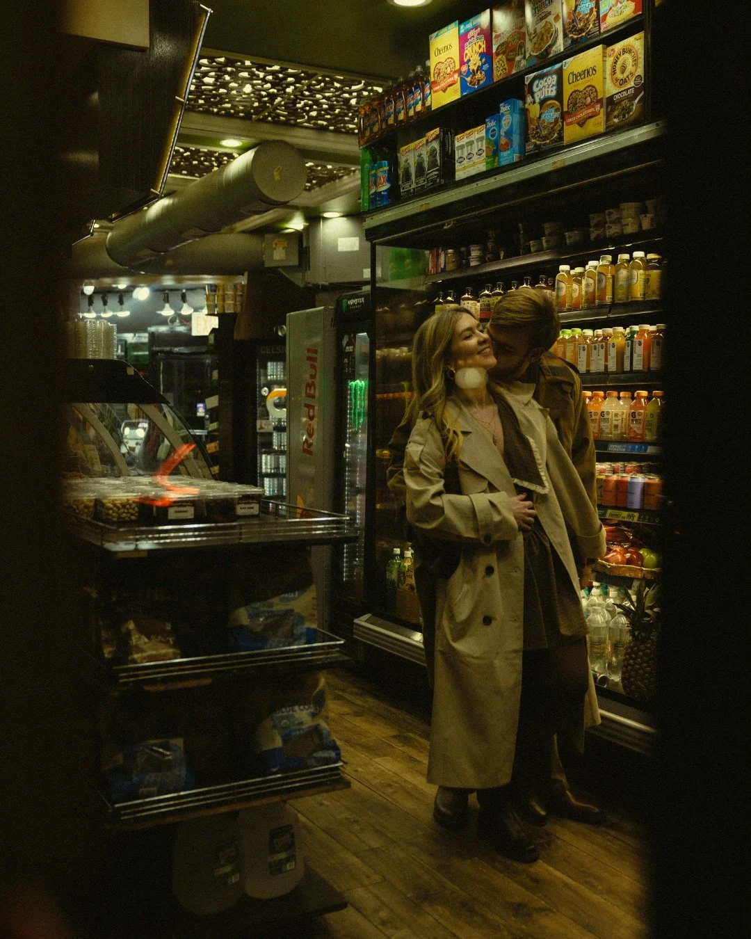 Couple kissing through bodega window in West Village