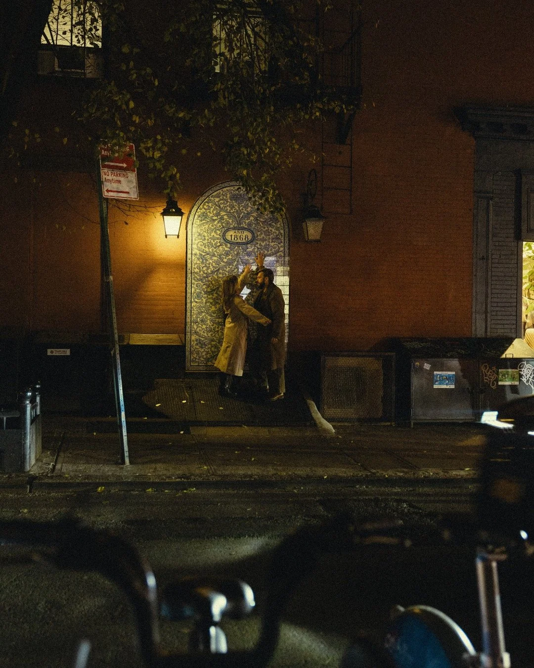 Couple sitting under Smalls doorway in West Village