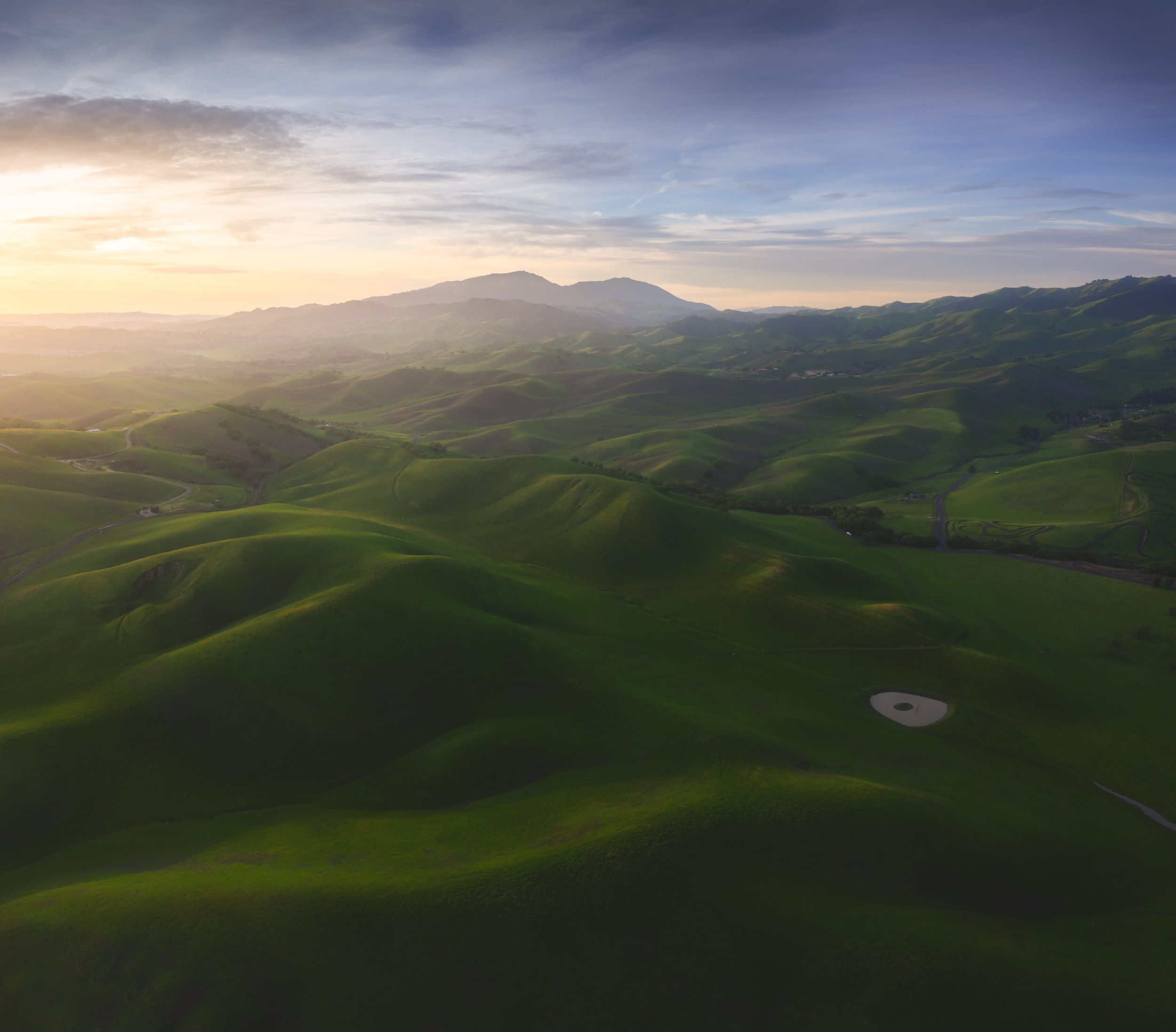 Sea of Green by Rajesh Subramanian 

Captured from an aerial perspective over the foothills of Morgan Territory in Livermore (Reinstein Ranch). In the peak of early spring, these slopes undergo a transformation that makes them a near-perfect match fo
