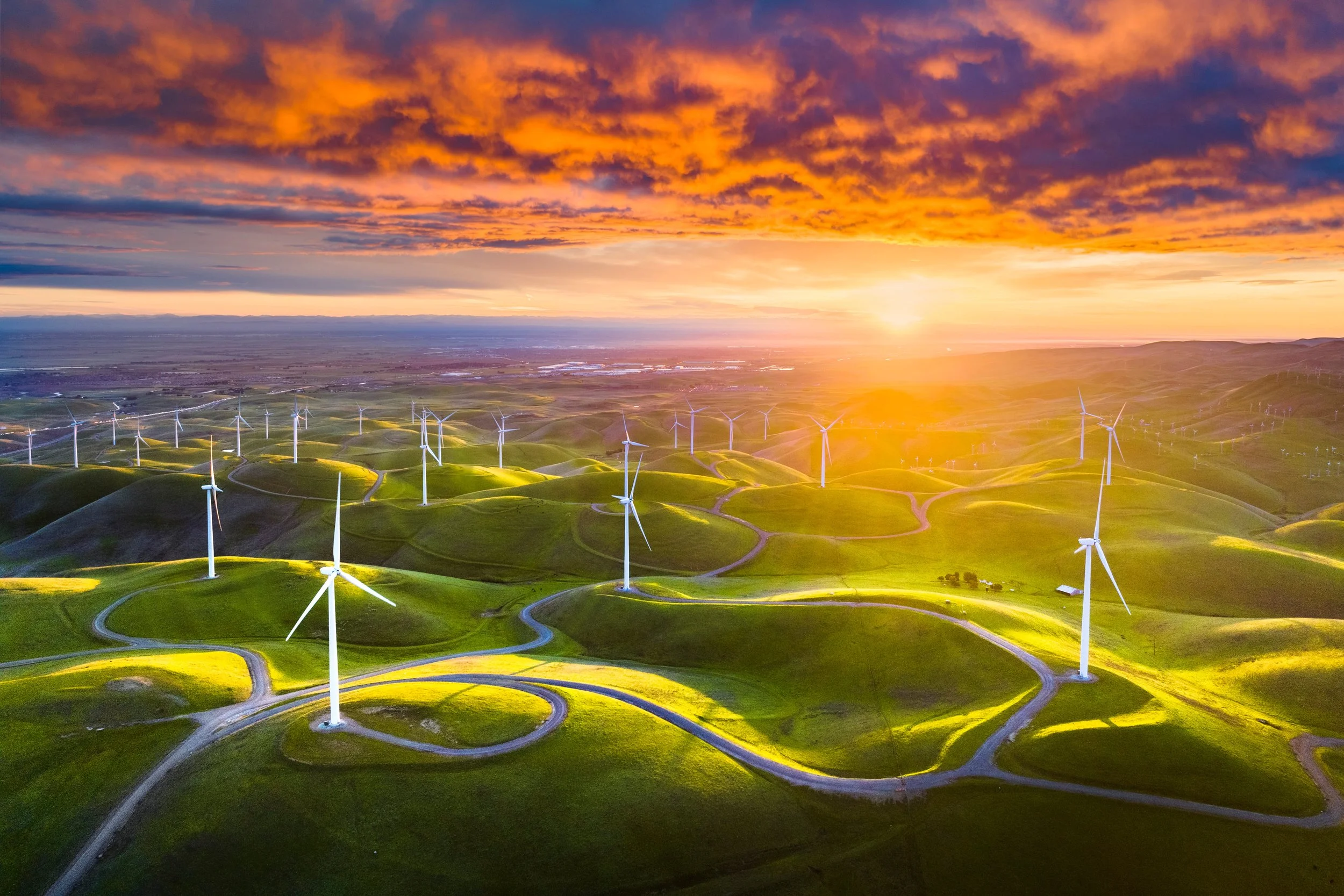 Altamont Ablaze by Josh Dye.

 An unbelievable sunrise over the Altamont Pass while the green hills and windmills below catch the first rays of sunlight.
