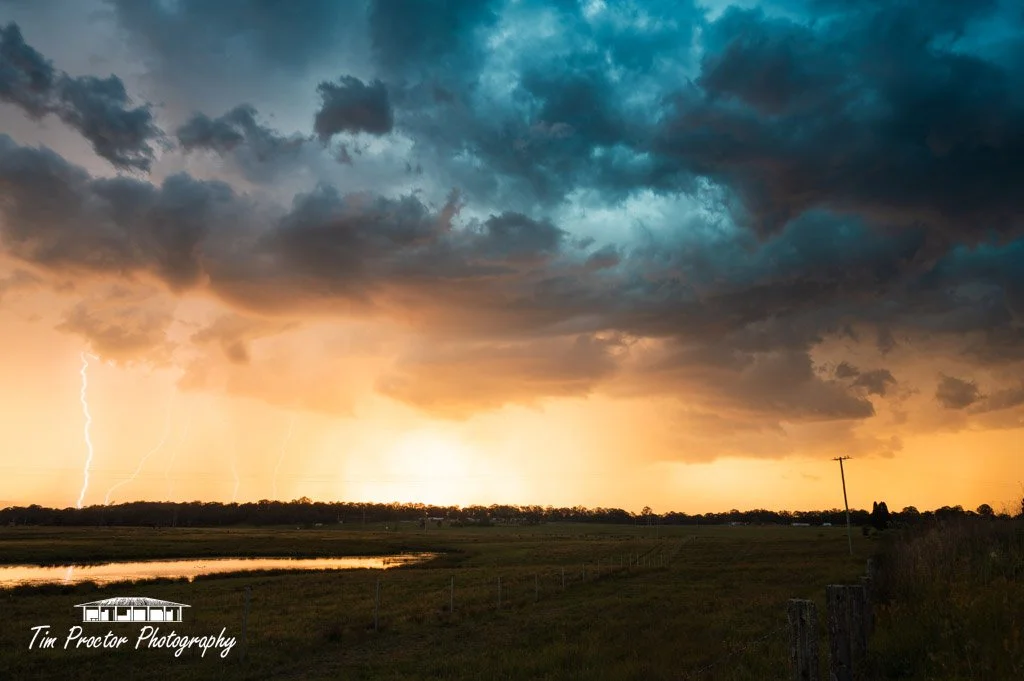 An incredible thunderstorm glows bright orange as it is backlit by the setting sun!