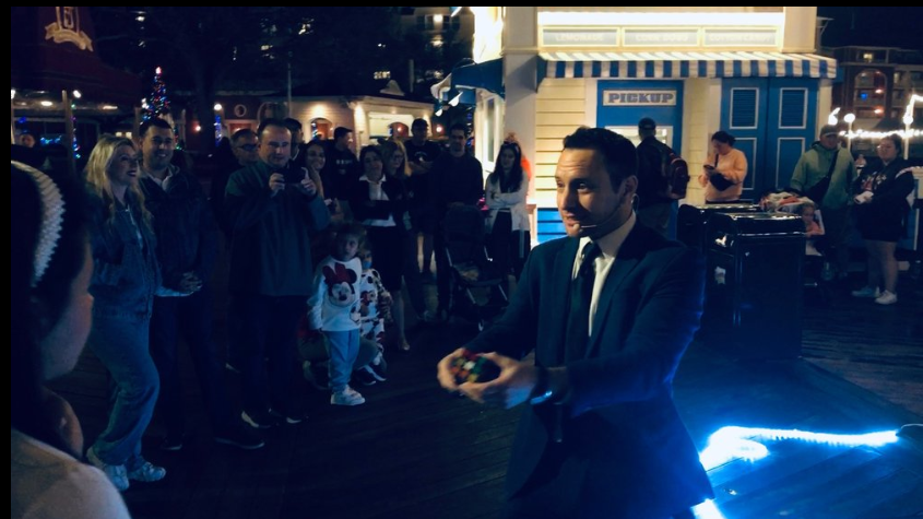 Ari Novick performing close-up magic at a corporate event in Atlanta.