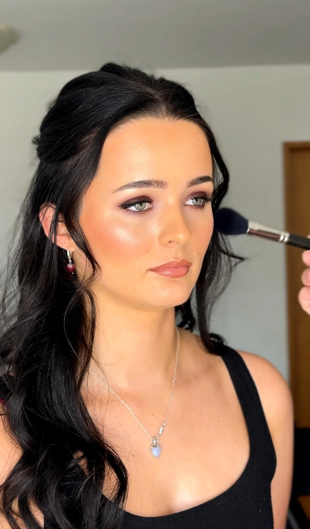 Burgundy special occasion makeup with smokey eye being applied by Christchurch makeup artist Steph