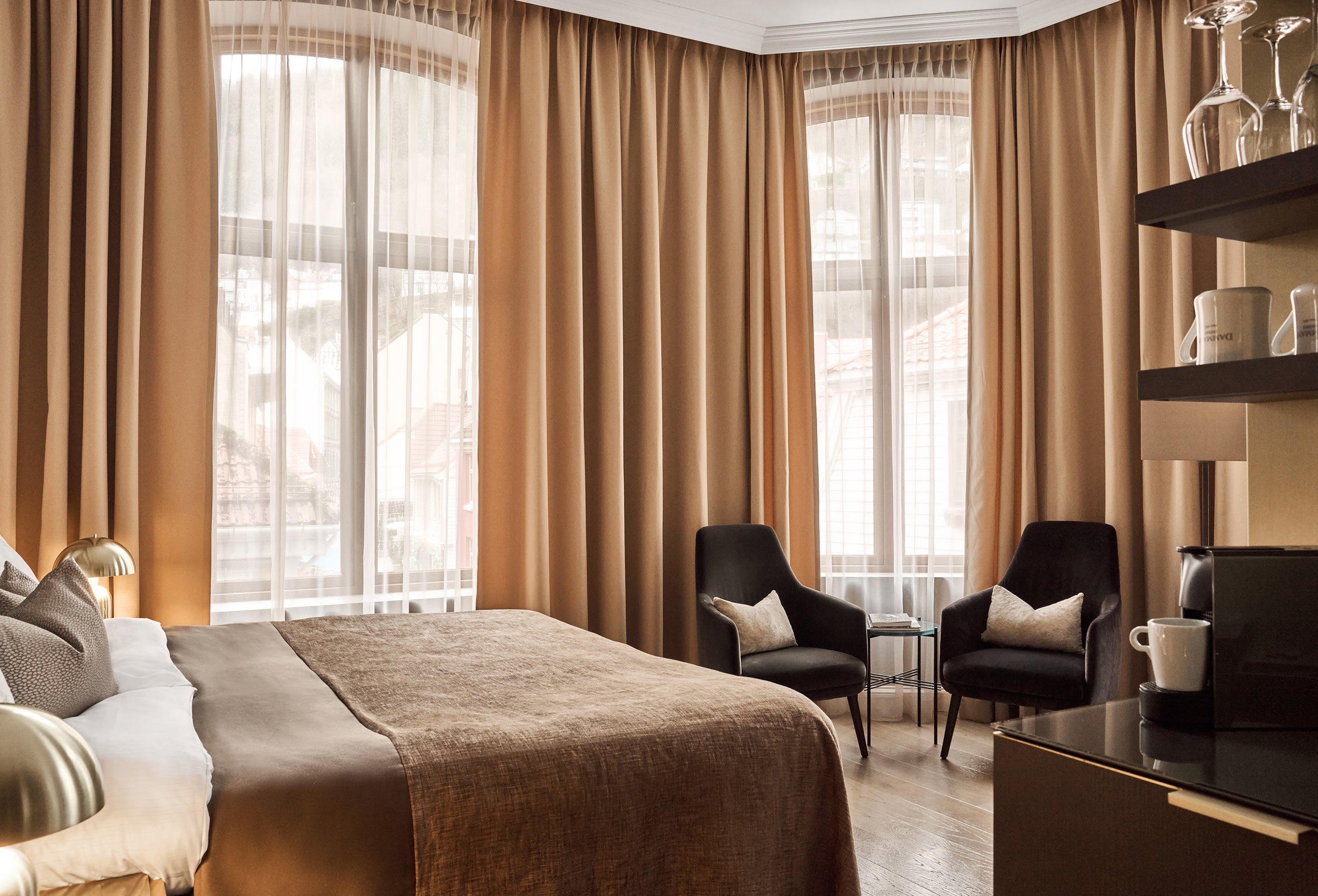 Deluxe City View Room at Opus 16 Hotel in Bergen featuring luxurious decor, premium bedding, and views of the city.
