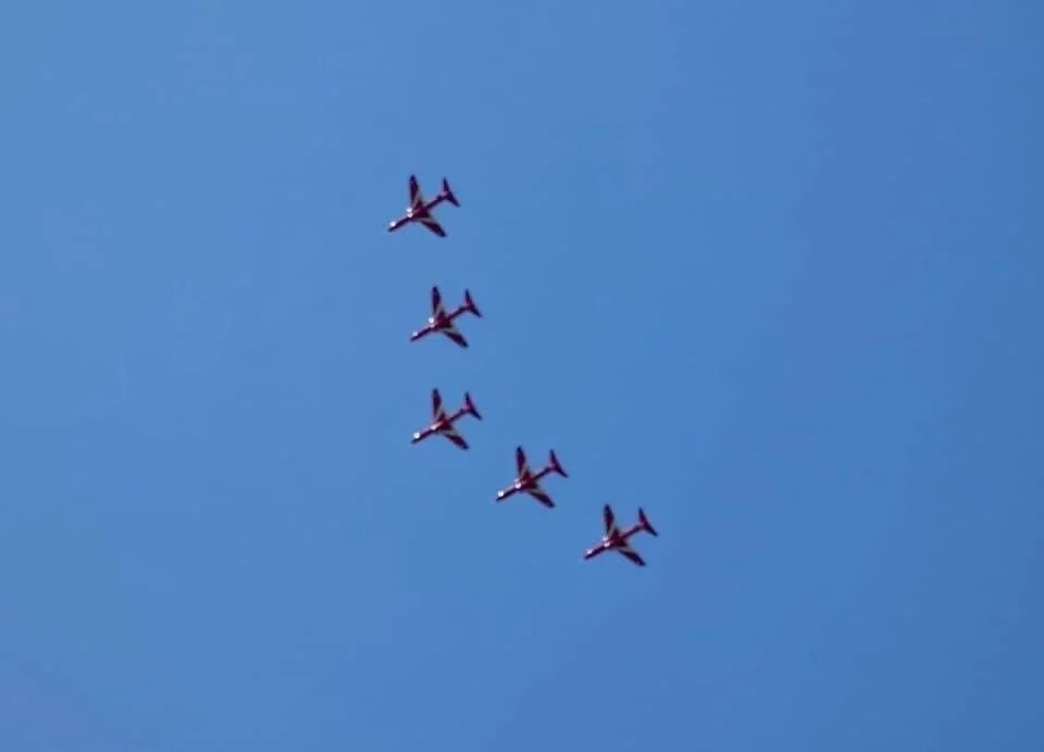 Red Arrows flying from RIAT over glamping site